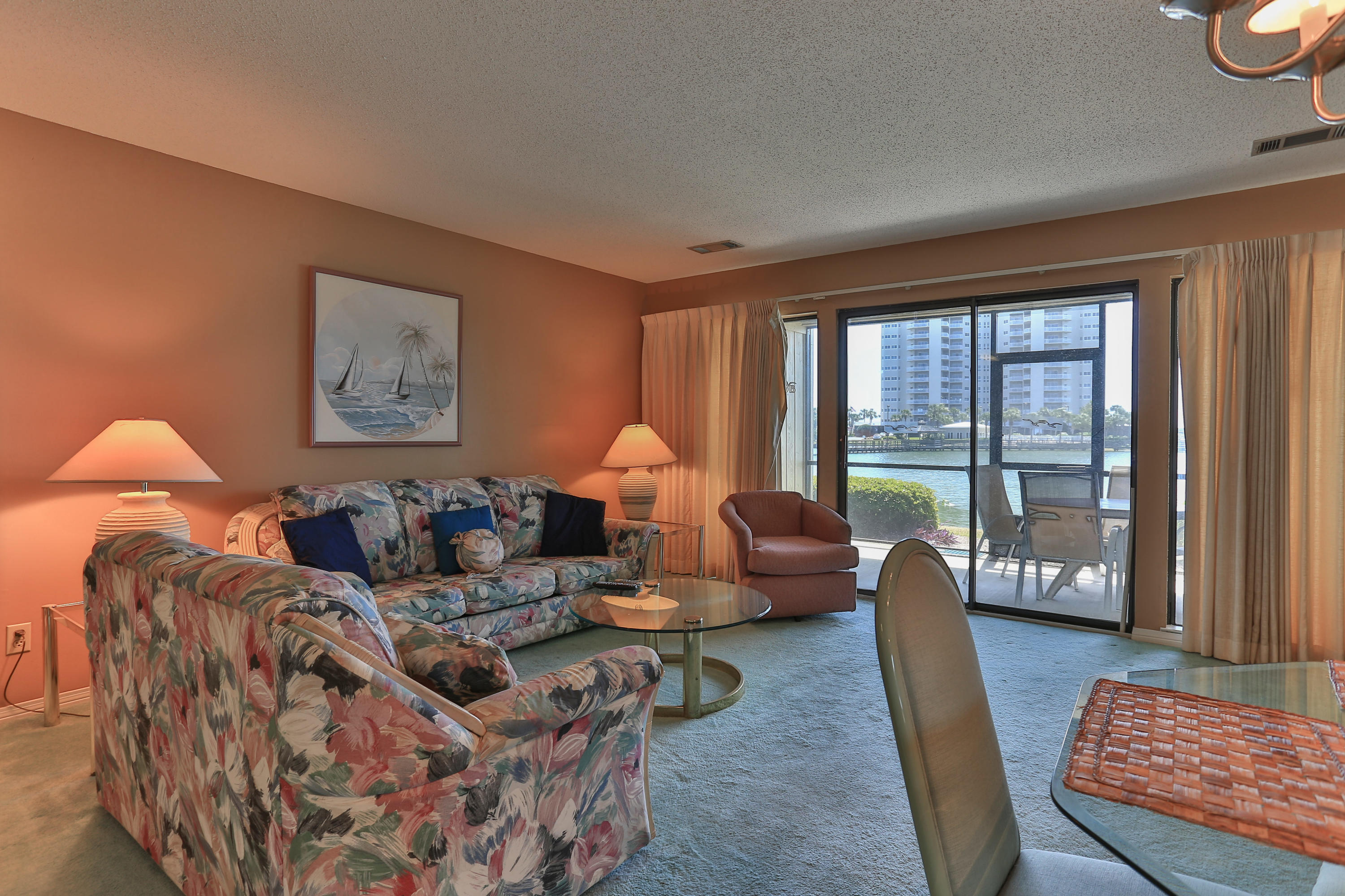 Sit and enjoy the view of Stewart Lake from the living area, kitchen and large screened-in porch. The open floor plan offers lots of storage plus an additional small sink at the entrance to the kitchen. This first floor unit is steps away from the swimming pool and the beach boardwalk. Seascape has deeded beach access. Seascape Resort has gated entrances, 18 hole golf course, tennis courts and pools. The Seascape Towne Centre offers restaurants, fun activities and shopping. All dimensions and information herein is deemed reliable, but should be verified by buyer.