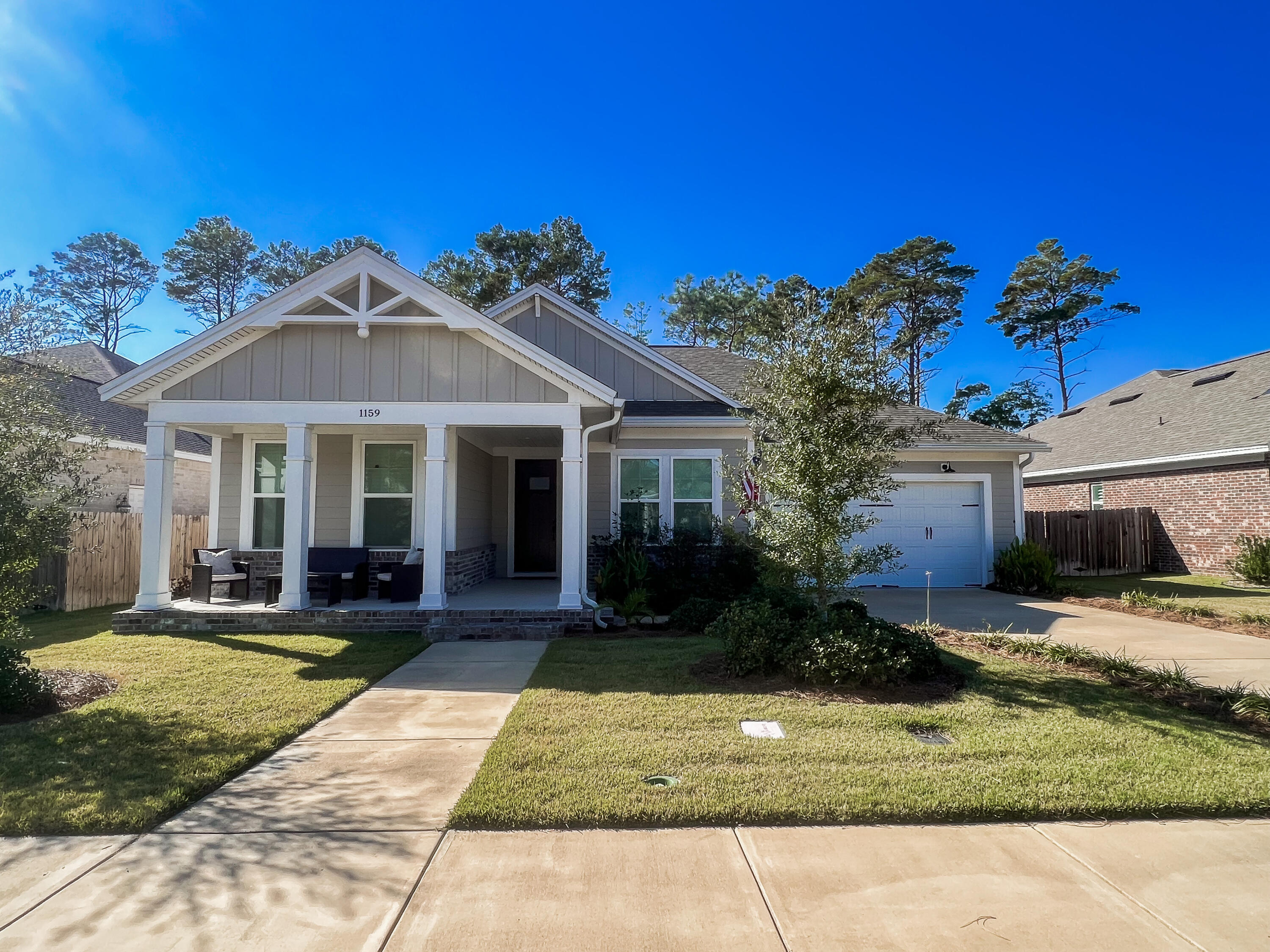 Welcome to Deer Moss Creek, where luxury meets comfort! This stunning home offers the perfect blend of modern design and convenient living. With 3 bedrooms and 2 bathrooms PLUS an office, this spacious abode provides ample space for all your needs. Step inside and be greeted by the sleek LVP flooring that adds a touch of elegance. The kitchen boasts beautiful quartz countertops & stainless steel appliances, perfect for preparing delicious meals or hosting gatherings with friends and loved ones. Cozy up by the brick fireplace in the living room, creating a warm and inviting atmosphere during those chilly evenings. The master bathroom features a luxurious walk-in shower, providing a spa-like experience right in the comfort of your own home. Step outside onto the custom patio w/ built-in  fire pit, where you can relax and unwind while enjoying the beautiful Florida weather. The garage features a full stairway to the attic, offering convenient storage. Located in the desirable Deer Moss Creek community, this home offers a peaceful and serene environment, perfect for those seeking tranquility. With its prime location, you'll have easy access to nearby military bases, schools and other amenities. Quick access to Hwy 293 makes getting to Destin a breeze!!! Don't miss out on the opportunity to make this Deer Moss Creek home your own. Schedule a tour today and experience the epitome of comfortable living!