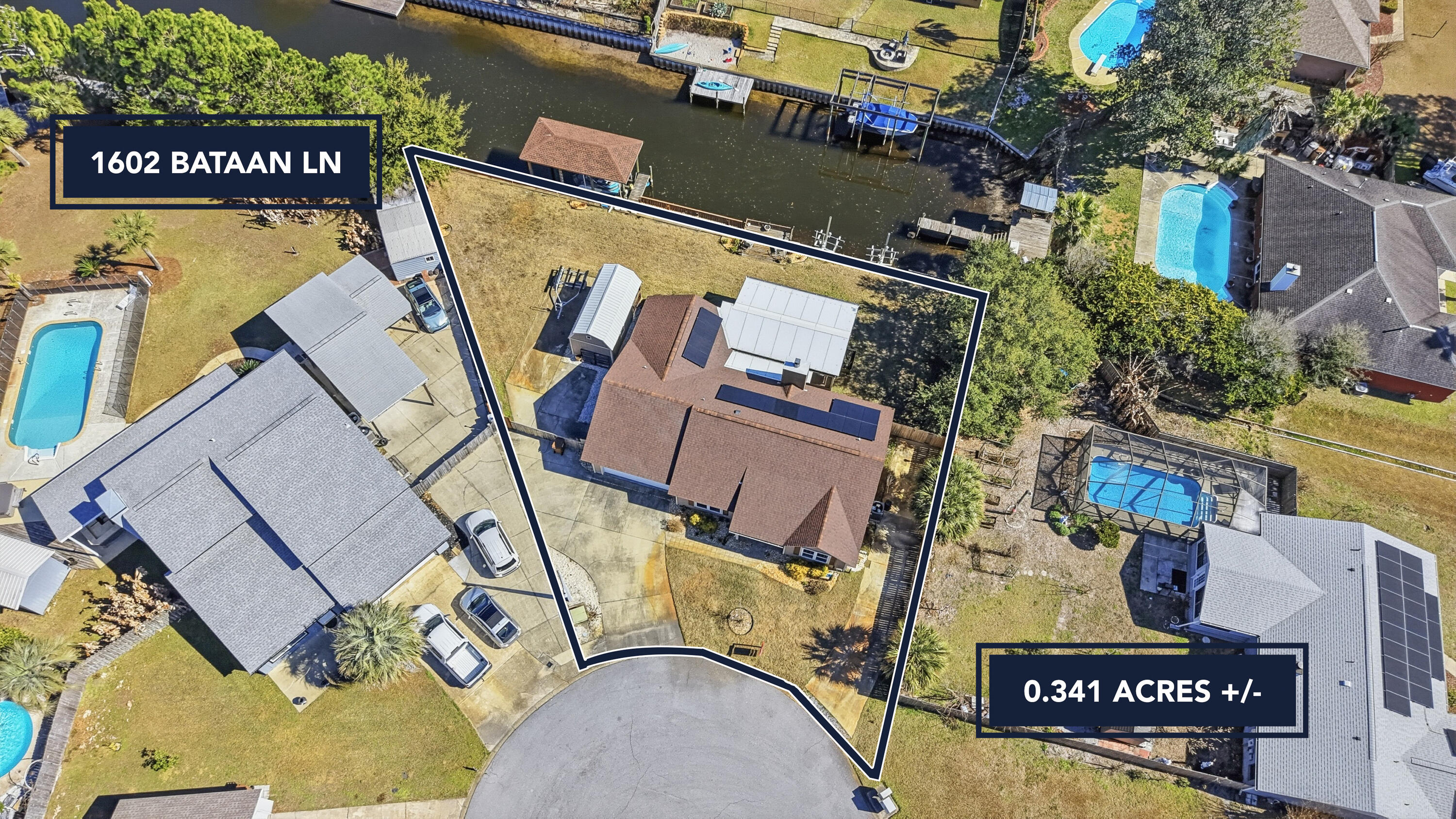 CANAL-FRONT Home with 150 feet of waterfront in desirable Polynesian Island, located on a cul-de-sac. This 3BR/2BA split floor plan residence offers exceptional comfort and functionality. Features include a NEW boathouse with new 10,000-lb Boat Lift (2024), NEW swim spa (2023), and NEW 20x20 screened-in porch (2023). Additional highlights include an additional driveway, RV parking with 50-amp hookup, heated and cooled garage with hurricane-rated garage door (2020), and a 10x20 storage shed with electric. Enjoy peace of mind with a whole-house generator, paid-off solar panels (2023), NEW windows (2019), Tankless water heater (2017), Roof (2017), and HVAC (2018). Waterfront living with exceptional utility and updates throughout.