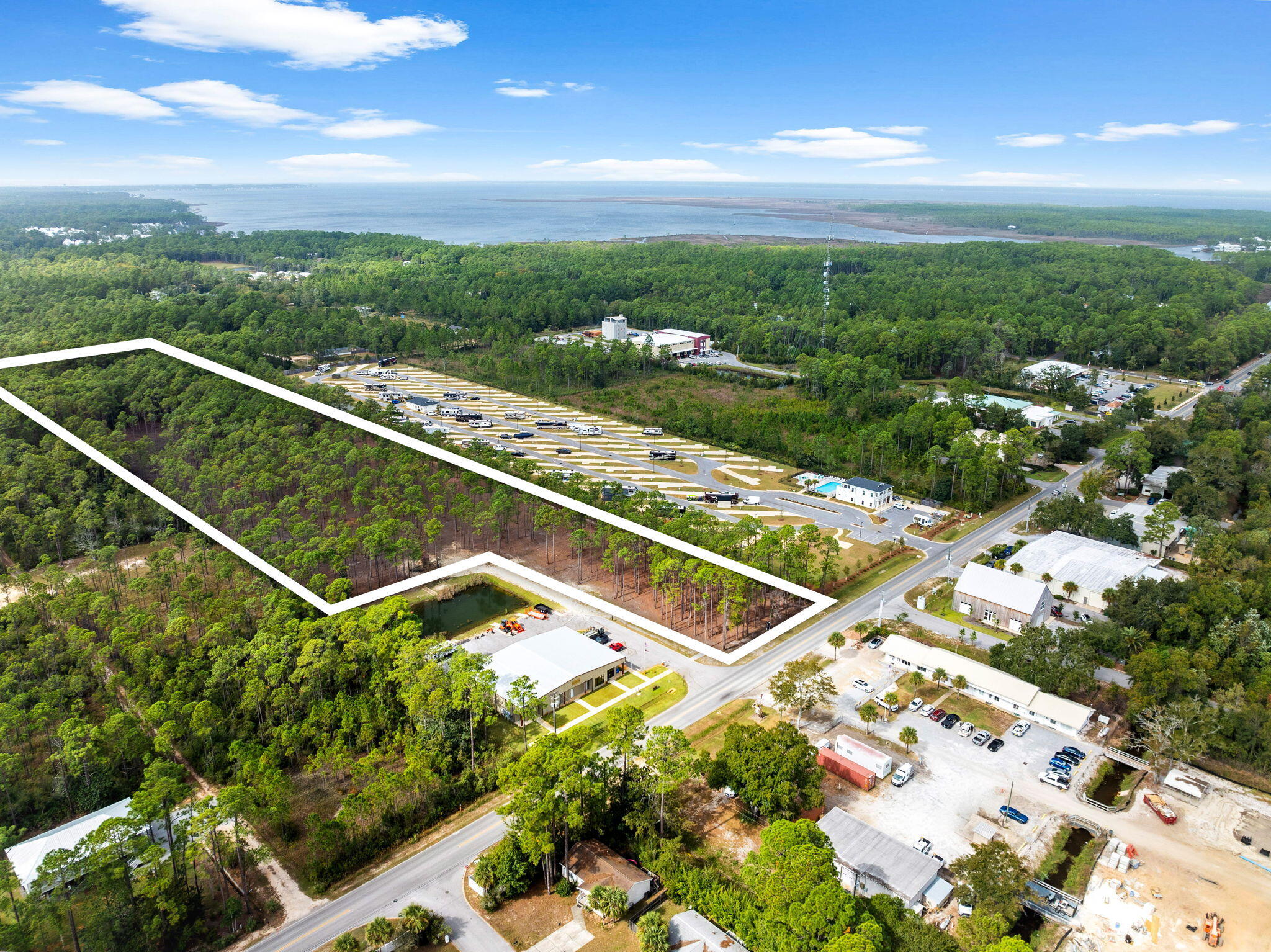 Unlock the potential of this high-visibility property along the rapidly developing corridor of N County Highway 393 in Santa Rosa Beach, FL. Offered per acre with a minimum purchase of 2.5 acres or up to 8.75 acres when combined with the adjacent parcel.

Positioned between US-98 and Chat Holley, the site is surrounded by light industrial parks and commercial growth, offering a strategic location for future development. The zoning is Neighborhood Infill (NI), which can support a variety of uses, including single-family homes, light industrial, live/work setups, or multifamily. Buyers are responsible for verifying allowable uses with Walton County Planning and Development. This is a flexible development opportunity in one of Santa Rosa Beach's most rapidly expanding corridors. Contact us today for pricing, survey details, or to discuss acreage configurations that best suit your vision. Please note: The existing warehouse on-site is not included in the sale. Seller financing available on a case by case basis.