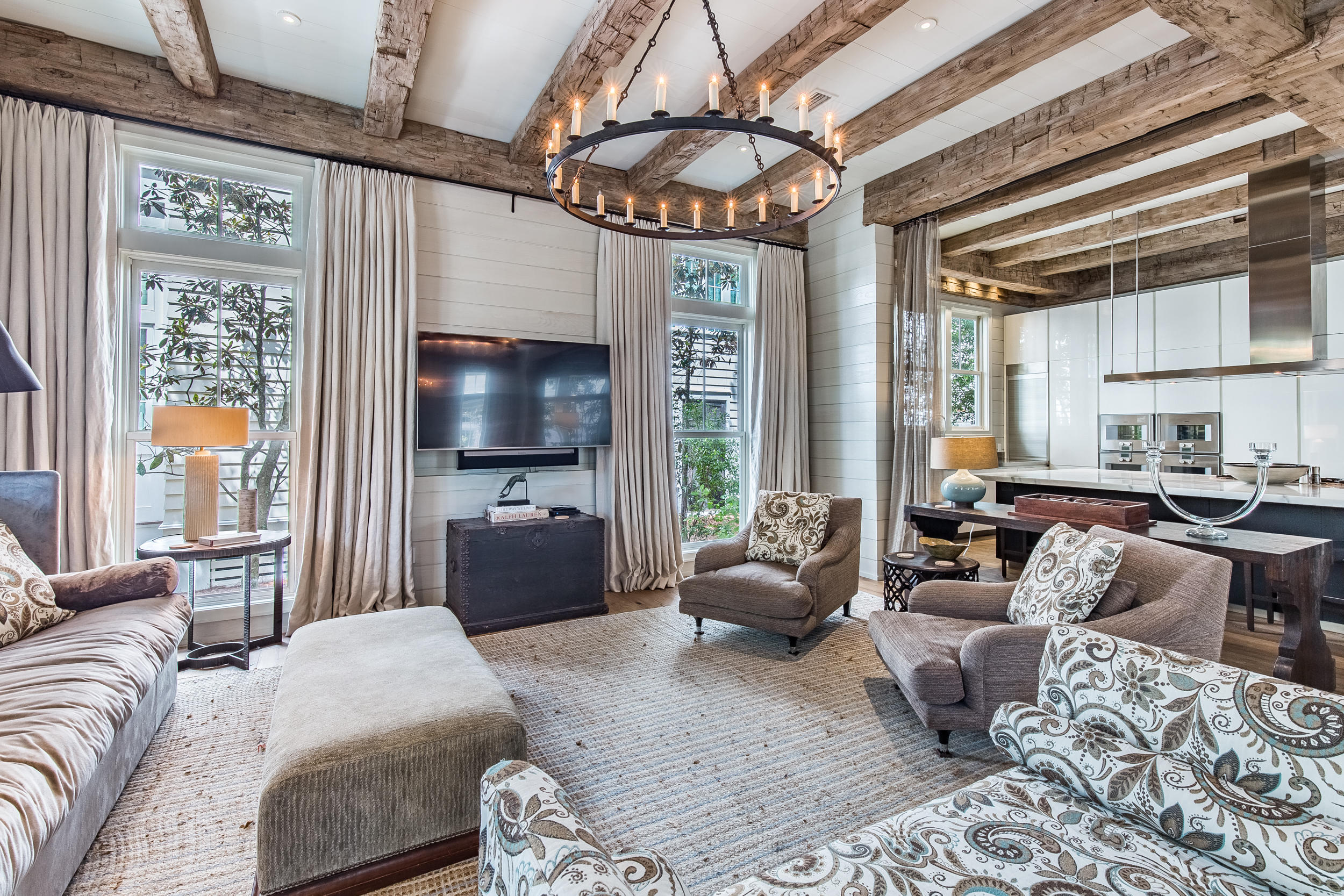 Find a refined yet comfortable atmosphere from the moment you enter this elegant WaterColor retreat with a 5BR main home, a 1BR attached guest home and a two-car garage. Conveniently located in Phase III across from the Frog pool, this property impresses with fine finishes at every turn including exposed antique ceiling beams, 100-year-old reclaimed white oak floors, Calcutta Gold polished marble counters and Pecky Cypress interior doors. Gather in the expansive and airy living and dining spaces highlighted by multiple seating areas, a dramatic stone fireplace, shiplap walls and floor-to-ceiling windows and doors. The stunning kitchen will wow any chef with luxury appointments such as a white Poliform Italian cabinets, a Gaggenau Hausgerate Vario gas cooktop, double ovens and ovens and double combi-steam ovens, a Gaggenau double-door refrigerator and freezer, a Sub-Zero wine refrigerator, two refrigeration drawers and a built-in Miele coffee system. A private and spacious master suite features a spa-like master bath, a separate sitting area and a covered porch that can be completely closed with tall slatted shutters. Beautiful guest suites allow you to easily accommodate family and friends including a stylish bunk room while a second story living area provides additional room to relax. The attached guest home can be accessed either through the main home or from an outdoor entry above the garage and features separate living and sleeping areas, a gourmet full kitchen and a covered balcony. Parking is a breeze with a double garage, driveway parking and additional recessed curbside parking at the front of the home. Located on 499 acres in the renowned South Walton beaches, WaterColor was created with families in mind and offers the charm of small-town life. Exceptional community amenities include six beautiful swimming pools, a Gulf front beach club, nature trails, a Boathouse offering kayaking, canoeing and paddleboarding, a fitness center, outstanding tennis facility, Camp WaterColor for kids, parks and green spaces.