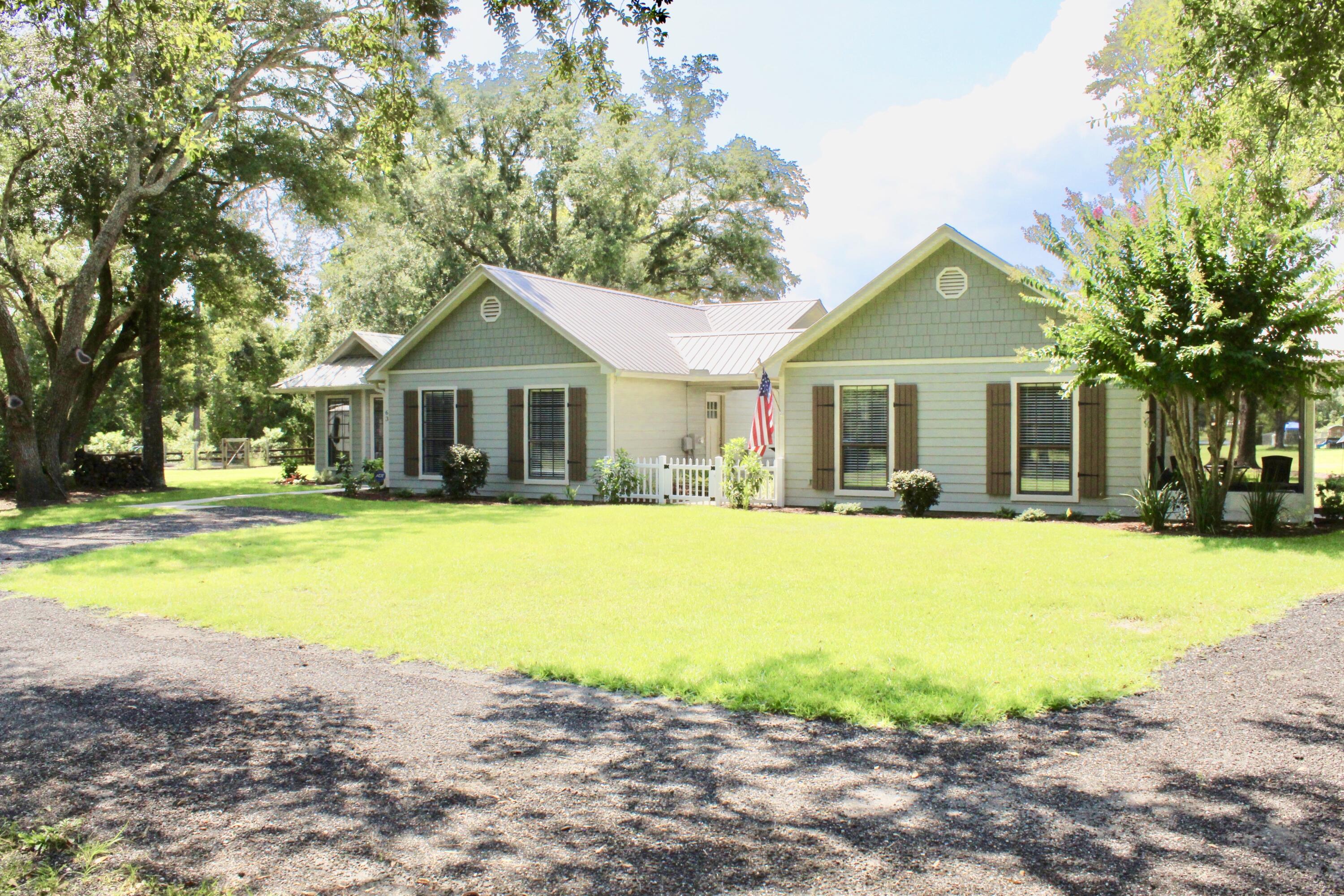 No HOA!  The main house has about 1430 sqf (feels much larger) with 4 bedrooms and 2 baths, family room with a wood burning fireplace, tongue and groove ceiling with beams, wood look flooring through out.  Granite counter tops, oversize laundry room and mud room entry thru courtyard. Separate guest house has 774 sqft and includes master with  laundry hook up, full size bath with walk in shower and kitchen family room combo. Both homes are truly breathtaking. This property is on over 1 acre, beautifully maintained. The Storage Shed is 24X30 and is heated and cooled, currently being used as workshop. The guest house has a covered walk way to the main house with concrete slab and lights, metal roof was installed in 2018, 2015 new AC and hot water heater. 3/car carport and a covered shed.
