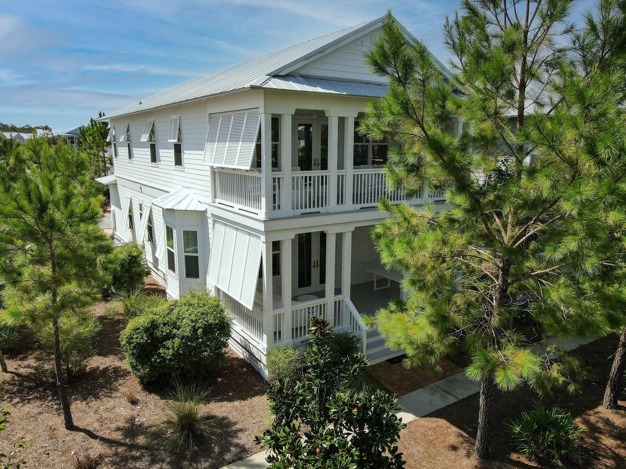 Luxury redefined at the beach. Designed with impeccable taste and stunning furnishings, this luxury property is a rare find. Each living space and bedroom has been curated with comfort and is the epitome of coastal living. Boasting an open floorplan, two master suites, three spacious porches, a custom bunkroom, newly fenced side yard, an outdoor pool table, and luxe finishes just to name a few. Situated on a generously oversized corner lot, a custom porch swing overlooks a serene greenspace. This home was recently added to the rental market for the first time, so a rare find in pristine condition  . Easily enjoyed as a vacation home oasis, turnkey investment property, or your next primary residence. Offered furnished with a top-of-the-line golf cart, this is the beach house you have been dreaming about. Located in 30A's Naturewalk at Seagrove, there are endless amenities to enjoy at your leisure. Including a spacious resort-style pool, heated lap pool, hot tub, outdoor kitchen, firepit, multi-purpose court, children's playground, fitness stations, nature trails, and a quiet path to the beach. Minutes from shopping, dining, and all that Seaside and Watercolor have to offer. This home is ready for you and your family to enjoy! This is a stunner.*Upgrades and Features list available upon request.