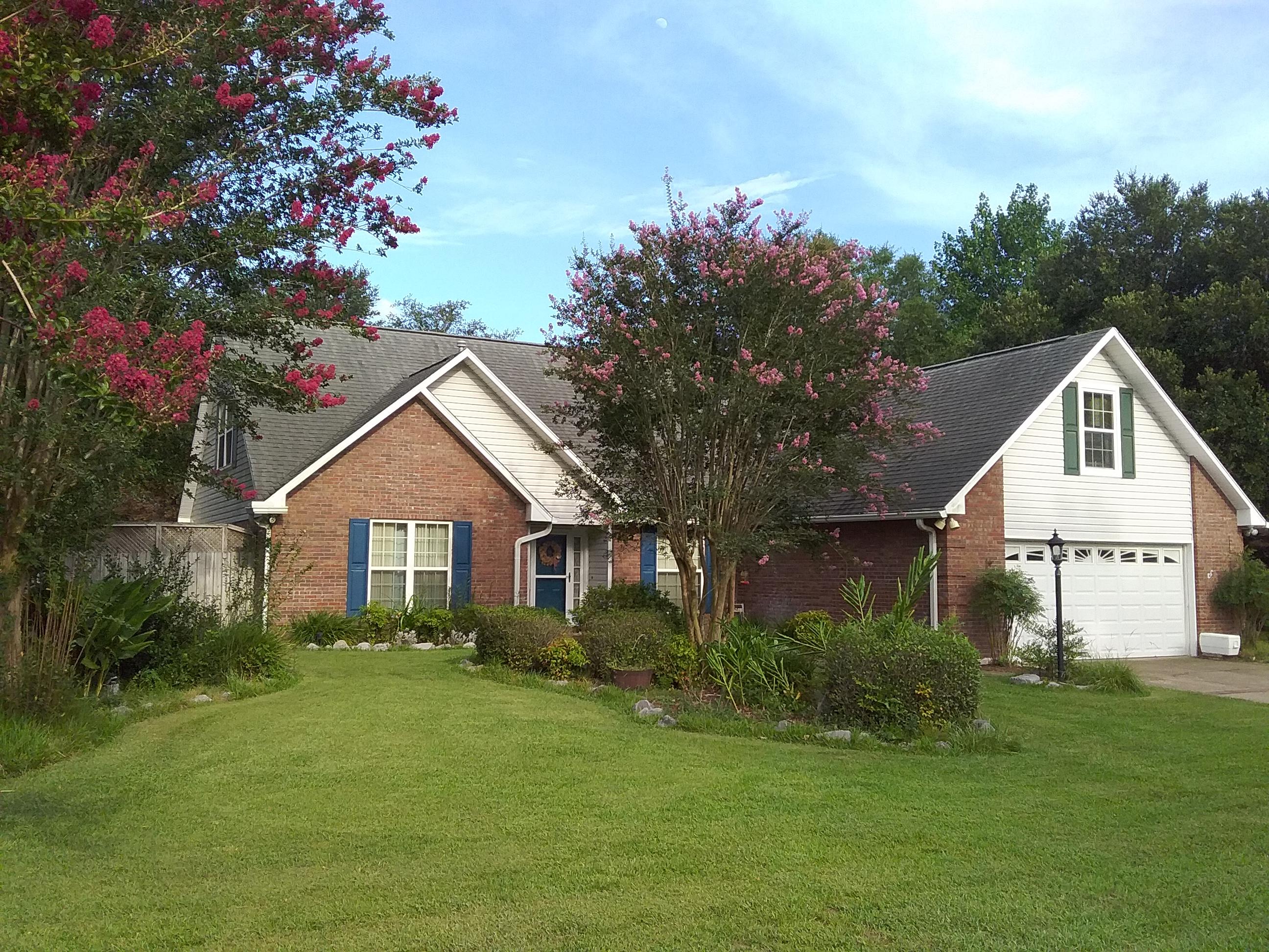 When you make it here, you've made it HOME! This spacious home south of I-10 is spectacular! This gorgeous landscaped lot has a privacy fence, sprinkler system, and power boxes inside the landscaped beds for outdoor lighting! The lot boasts a large covered RV/boat area with concrete pad, 50 amp connection, and roller at the bottom of the gate for ease and convenience of parking. Behind the carport is a separate workshop, complete with workbench & electricity for that power tool enthusiast & late night project hero! Nestled behind the workshop is a lovely fenced garden area with raised flower beds. Along the back yard is a lighted privacy fence providing the perfect setting for entertaining friends and hanging out with family. The gas hook-up is essential for traditional summer grilling! Hot tub & pool hook-up is available within the private backyard. The 2-car garage with new door opener/coil has generous room for a freezer and 2nd refrigerator. The garage also has shelving, a multitude of cabinets, and generator hook-up. From the garage, the laundry room with ample cabinetry and built-in ironing board leads to the kitchen. The sensational kitchen has custom Alder shaker cabinetry with dovetailed sliding cabinet shelves, a lazy Susan, recessed lighting under the cabinets, and a new dishwasher.  Cooking and dining is relaxing in this professionally designed eat-in kitchen with granite counter tops, tile back splash, power supplied island, and a custom oak table that conveys! To prepare delicious meals, this kitchen is equipped with a dual fuel gas/electric stove and a convection/microwave hood. A recreational room contains several windows for warm sunshine, a built-in surround sound system, recessed lighting for entertaining, and access to the covered side grilling porch with gas hook-up. An additional Florida room provides abundant space for a home office or exercise room. The downstairs has a hardwood floor master bedroom with en suite bathroom that encompasses a whirlpool/spa bathtub with handheld for both tub and shower, mirrored medicine cabinet, pull-out shelving and walk-in closet. The split-floor plan includes two additional bedrooms and a full bathroom. The inviting entrance to this incredible home is tiled and offers open views to the living room and formal dining room, both with crown molding, chair railing, and Brazilian cherry hardwood floors. The living room provides beauty and warmth with lighted display shelves and a cozy wood-burning fireplace. Upstairs is a study loft, a full hall bath, two huge bedrooms and a fantastic 19'x18' second master suite with a private bath and walk in closet! You will also appreciate that this large family home close to shopping, restaurants, and military bases south of I-10 has an ADT security alarm system, central vacuum, extra tiles for the foyer, a gas water heater, dimensional shingled roof (replaced 2008), and two A/C units with UV lights to kill germs, replaced downstairs in 2016 and upstairs in 2017. This beloved home is ready to be filled with love and laughter. Park next to the lamp post and come see why this is the perfect place for you!