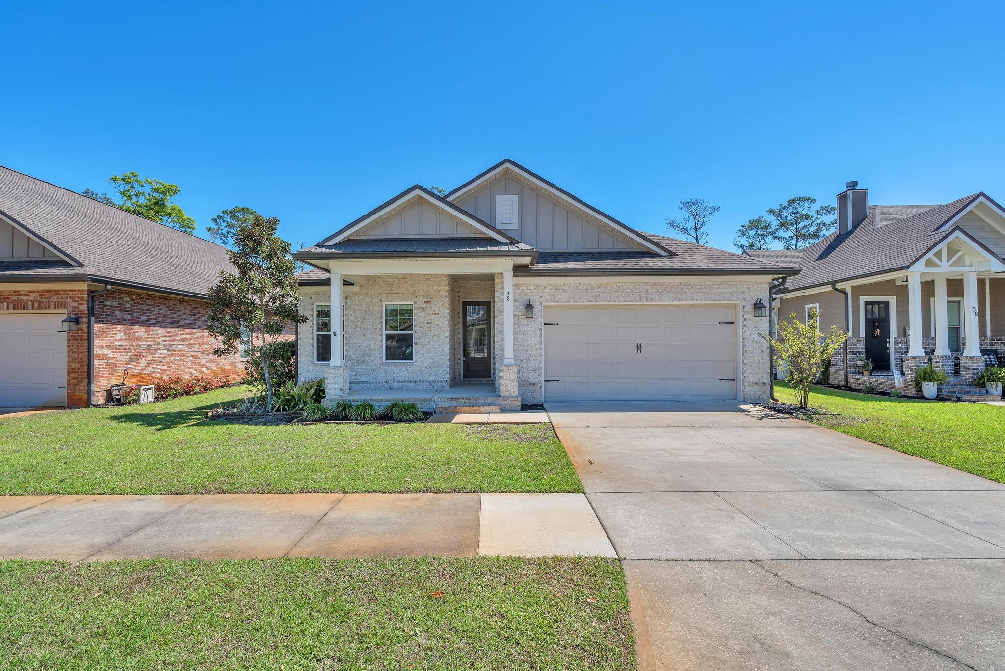 Within proximity to the Freeport Marina in beautiful Marina Village, this like new home offers 3 Bedrooms a flex room with laminate floors and double doors, 2 1/2 baths. Brick exterior, covered entry, large covered, screened rear porch, 2-car garage, and landscaped with sprinkler system. Interior upgrades: 9' ceilings, 8' doors throughout, crown molding, cased openings and windows, oil rubbed bronze package. Tiled shower and heated whirlpool tub w tiled deck, double vanity and walk in closet in master. Laminate, tile and carpet floor coverings, kitchen back splash, stainless steel appliances, quartz countertops w/extended island/breakfast bar w/painted legs, ceiling fans, laundry room has upper/lower cabinets. The fenced in backyard overlooks the private, wooded federal preserve.