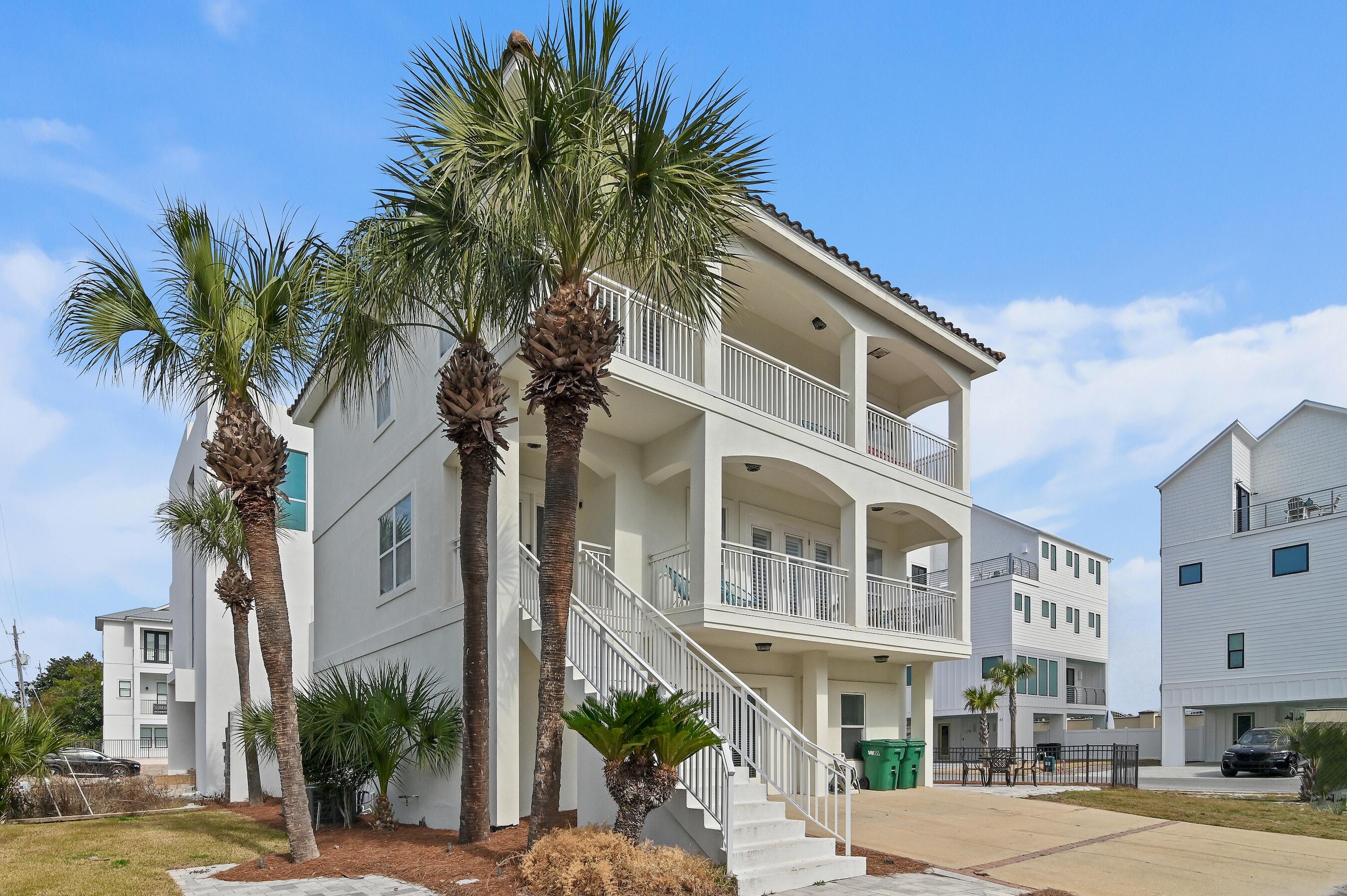 Looking for the perfect rental investment or personal beach retreat? This is it! Steps from the beach with no HOA, this spacious coastal home sits on a prime corner lot with generous outdoor living space—ideal for sunbathing, grilling, and even adding a pool. The ground floor features a game room, built-in bunks for six, plus king and queen suites with private baths. The second floor boasts an open-concept living area, dining space, and another king suite. The third-floor primary suite offers a fireplace, bunks, spa-like bath, plus an additional queen suite and loft area. Walk to dining, shopping, and more! Located just 100 yards from beach access, this home is close to things like Surf Hut, Silver Sands Outlets, Sandestin Resort, Destin Commons, 30A No busy streets, just a short walk to the sand! Whether you're looking for a high-performing rental property or a personal beach escape, this home delivers the best of both. Schedule your showing today!