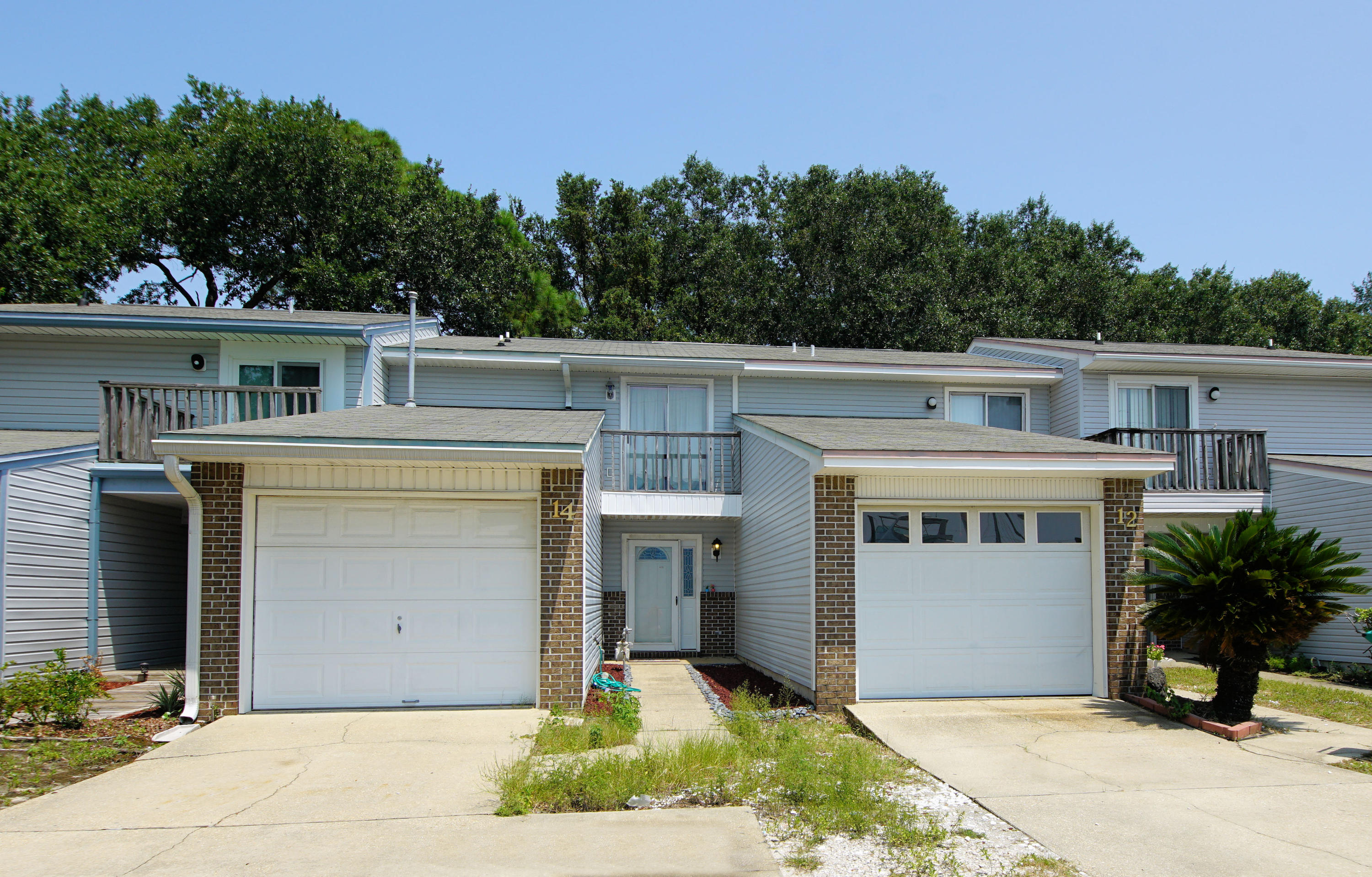 Two-story townhome near the Shalimar Yacht Basin with 2 bedrooms and 2.5 Baths and 1144 sq ft! There is a view of the water from the front balcony! Store your boat and Jet Ski close to your home and take be on the water in less than 15 minutes. This townhome features an attached one car garage, multiple balconies, and a fenced yard! Enter the home and notice the kitchen opens to the living room! The living room features a fireplace and tiled flooring! The kitchen has a slide in stove/oven, microwave, refrigerator, and dishwasher. There is a half bath downstairs for guest! Upstairs there are two large bedrooms and 2 full baths! This town home features walk in closets and ceiling fans! The bathrooms have been renovated with new vanities, mirrors and faucets! There are raised panel doors throughout and sliding glass doors in both the living room and the master bedroom! This town home is so close to the water you can see the water from the front balcony! You can launch a boat just minutes from this home! You can not get a better location than this!  Buyer to verify all information and dimensions!