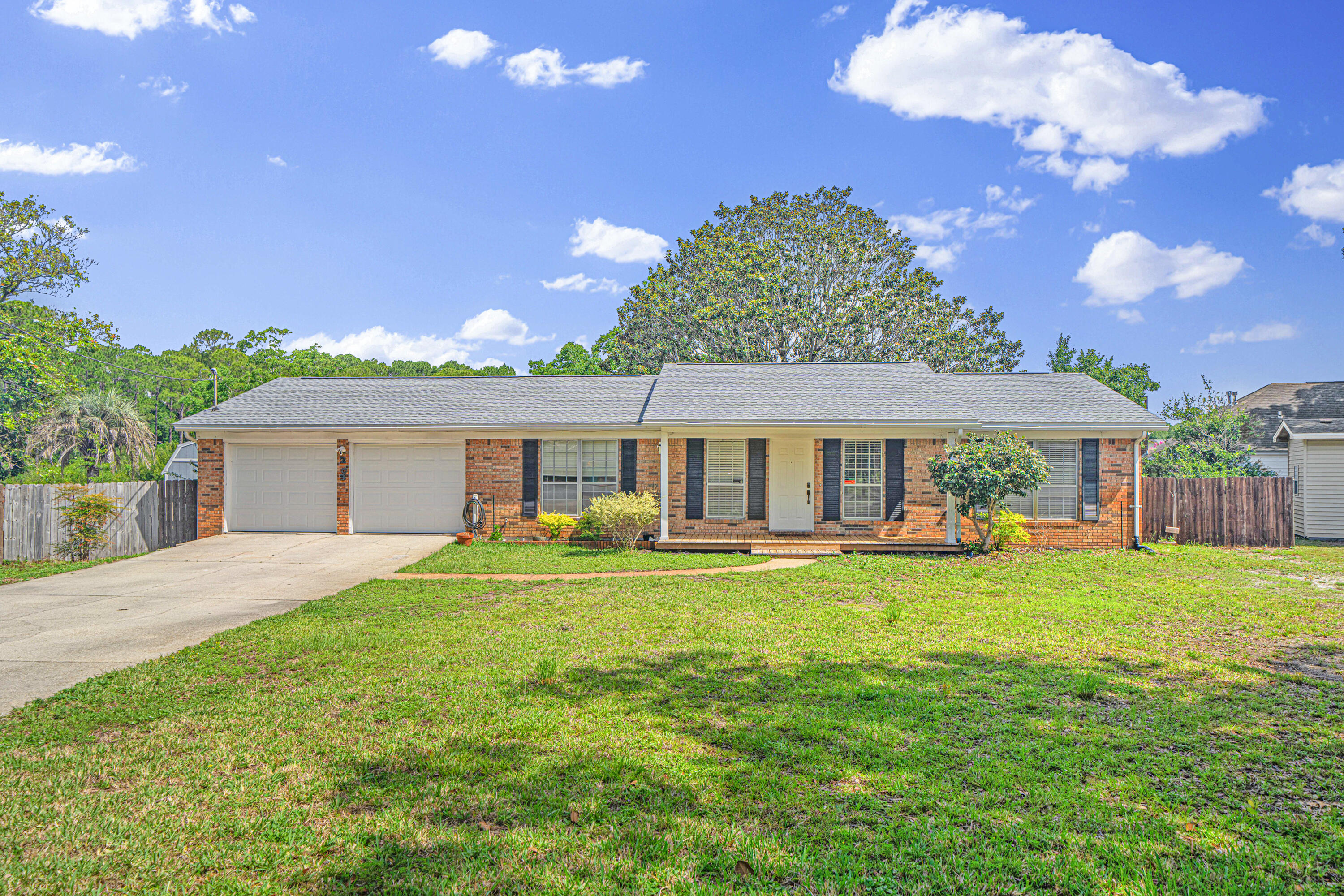 Your Lakefront Retreat Awaits! Welcome to 203 Elizabeth Court! Tucked away at the end of a quiet cul-de-sac, this charming lakefront home is the perfect blend of comfort, privacy, and serene outdoor living. With a newer roof (2022) and AC unit (2022) and water heater (2019), this property is move-in ready, full of unique features and no HOA fees.

From the moment you pull into the long driveway and step into the oversized two-car garage, you'll feel right at home. Pass through the spacious workshop and laundry room and step into the heart of the home—your welcoming kitchen that flows seamlessly into the expansive living area. Featuring recessed lighting and a beautiful brick fireplace, this open-concept space is perfect for relaxing evenings or entertaining guests.