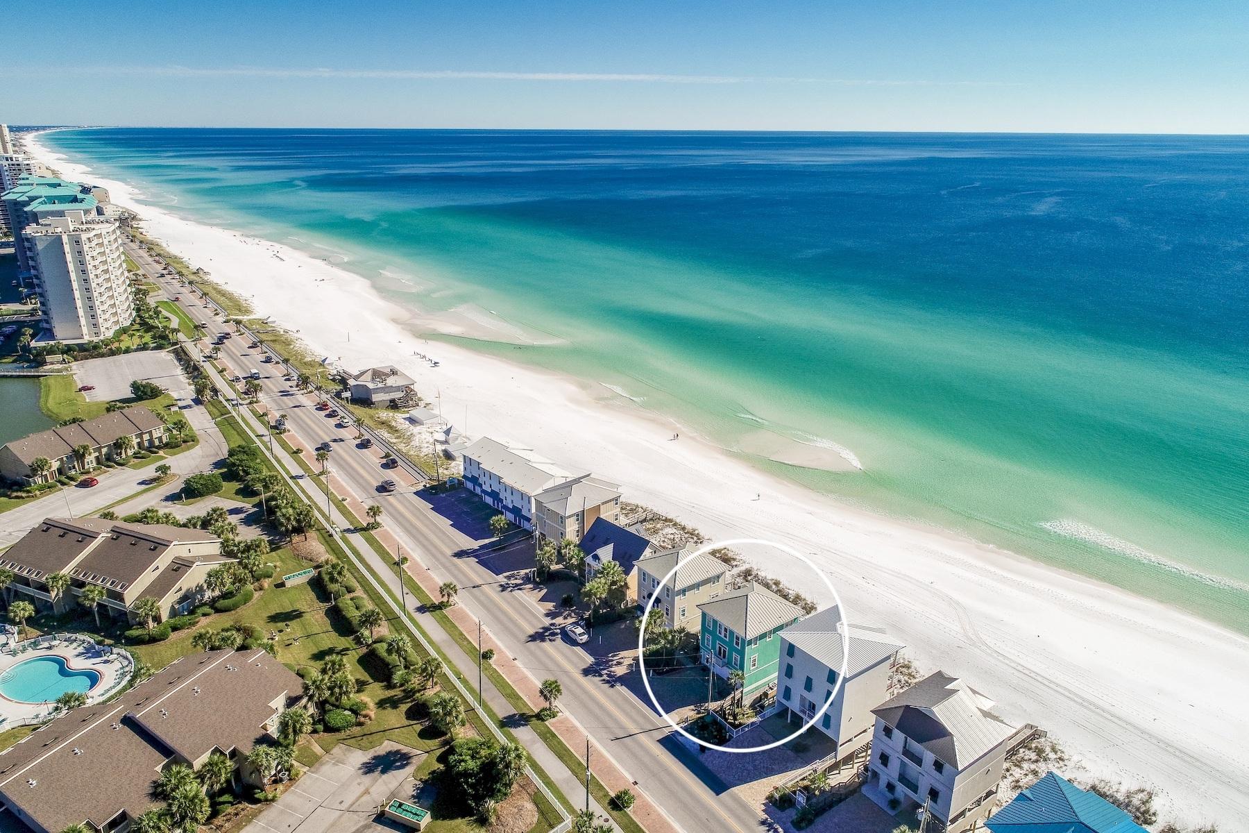 Experience unparalleled gulf front vistas from this prominently located beach front retreat primely positioned on 50' of premium linear gulf frontage highlighted by three stories of coveted south facing deck space. This exemplary five bedroom rental machine has been recently updated and well designed for optimal income potential offering $175,000-$200,000 projected gross annual income. Notable features include ample exterior parking as well as a spacious two car garage with additional storage for beach equipment. The open floorplan is an immediate highlight with a functional set up allowing for two spacious gulf front bedrooms on the first level sharing a jack-and-jill bathroom and allowing immediate access to the rear decks & subsequent path to the beach. The awe-spiring kitchen and living area define the second floor living offering endless gulf views from every corner of the space framed by an abundance of floor to ceiling glass windows. The wide open chef's kitchen is well designed with stainless appliances and granite countertops as well as ample custom cabinetry for storage. The living room features plenty of seating space and is open to the dining and kitchen area anchored by a gas fireplace for added ambience while enjoying winter sunsets over the Gulf of Mexico. The second floor indoor living area extends directly to premier covered outdoor living space soaking in the 180 degree pristine gulf views. The third floor master suite is the pinnacle of gulf front living with an expansive layout offering extraordinary gulf views as well as a full ensuite bathroom recently updated with dual vanities, walk in shower and soaking tub. There are two  additional bedroom suites located on the third floor complete with an ensuite bathroom. This outstanding gulf front home is located within close proximity to all of the world class amenities in Miramar Beach including shopping, dining, entertainment, golf courses as well as the outlet mall of Sandestin and the surrounding resort amenities.