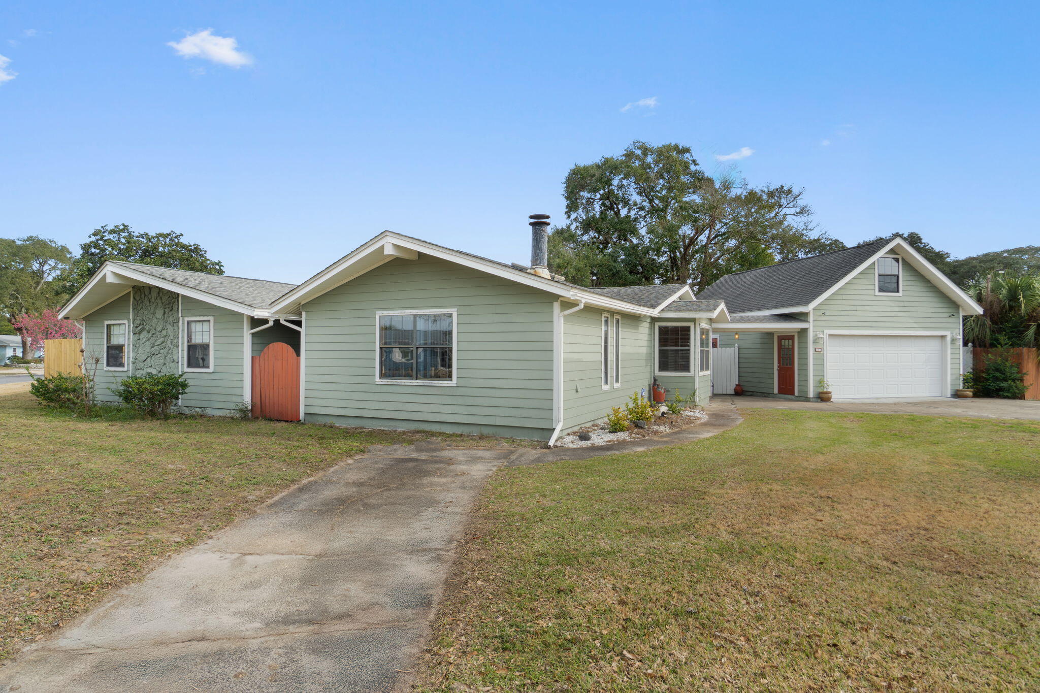 Fantastic opportunity in the heart of Fort Walton Beach awaits. Situated on an oversized corner lot with no HOA, this light-filled three-bedroom, two-bath home offers 2,192 square feet of well-designed living space with strong fundamentals and room to personalize. Offered as-is, the home features copper wiring, a 2018 HVAC system, a freshly painted interior, repaired deck, updated skylight, and full hurricane shutters for added peace of mind. 

The functional floor plan includes a spacious living area with a wood-burning fireplace, a formal dining room, a full-size laundry room with built-in storage and folding area, and a well-appointed kitchen with solid cabinetry, granite countertops, pantry, stainless steel appliances, double oven, flat stovetop, and vent hood. The generous primary suite offers private backyard access, a large walk-in closet with built-in vanity, and an ensuite bath with double vanity and oversized soaking tub with tub/shower combo. Two additional bedrooms are filled with natural light and share a guest bathroom featuring a walk-in shower. 

Step outside to a private backyard oasis ideal for entertaining, complete with a covered back porch, large tanning deck, spacious fenced yard, additional storage building, and a well-maintained in-ground pool originally installed in 1996 with a seven-foot depth. Pool improvements include a new liner (2022), sand filter (2022), pool pump replaced in 2020, a spare pool pump, and a recently replaced chlorinator. The expansive two-car garage with additional room for a work area, added in 2011, features additional separate living space above with a shower and toilet, making it ideal for storage, office, or hobby use. This home also features 2 driveways allowing for ample parking for vehicles, boats, or recreational toys

Ideally located just minutes from the sugar-white sand beaches of Okaloosa Island and the waters of Choctawhatchee Bay, with quick access to Eglin Air Force Base and Hurlburt Field. Enjoy nearby shopping, dining, and entertainment in Downtown Fort Walton Beach, along with close proximity to grocery stores, medical facilities, parks, waterfront walking paths, and public boat launches. *New roof and water heater to be provided at closing with an acceptable offer. **Property may be purchased individually or together with the adjacent parcel at 105 SW Cedar Avenue for a combined ±0.64-acre opportunity