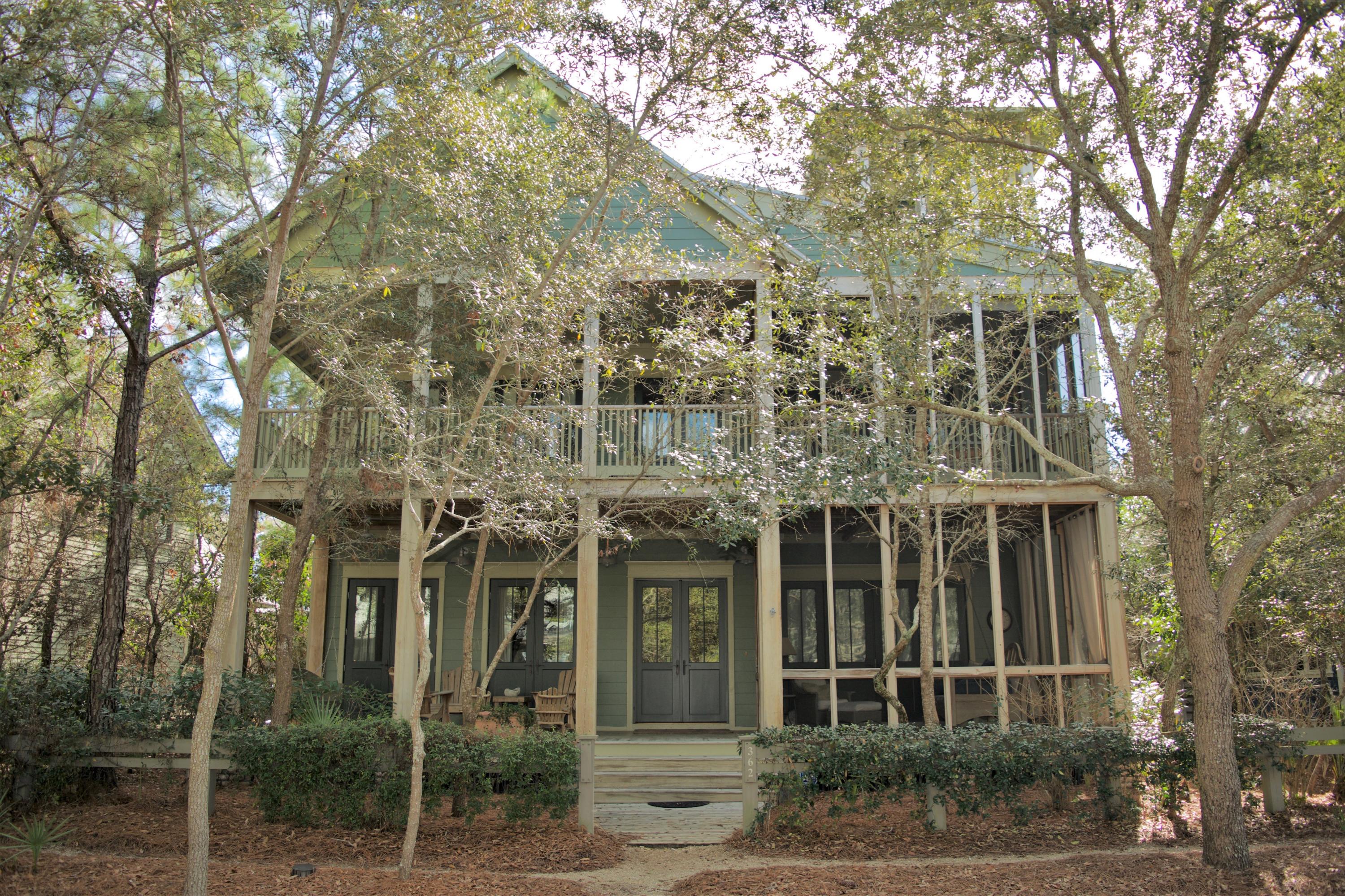 Nestled among the native pines and situated along Western Lake Drive in Phase 1 of the coveted community of WaterColor, this 5 bedroom, 5 -1/2 bath home welcomes you with an expansive covered front porch, warm wood tones and cozy wooden rockers. The exterior of the home is blanketed with desirable outdoor living space on each level, offering two covered verandas and three screened-in porches with hanging beds and comfy outdoor furniture. As you enter the home you are greeted with beautiful hardwood floors, shiplap walls and high ceilings throughout. Warm up next to the stately brick fireplace or kick back and converse in the spacious living room. The open-concept floor plan transports you into the homes expansive kitchen, fit for a chef, offering a large center island with a breakfast bar, granite countertops, and stainless steel appliances. The large dining room offers a great space for entertaining guests. The spacious laundry room, located behind the kitchen, also features a conveniently located pantry and additional storage space. The sought-after main floor master suite offers a garden tub, glass shower, pocket door and access to a screened-in porch. Three guest suites can be found on the 2nd floor, all offering direct access to the open-air living space perfect for relaxing with a good book. The third level of the home features a crow's nest and offers panoramic views of WaterColor and Western Lake. This home also features a spacious, appointed carriage house with vaulted ceilings, a two car garage, an outdoor shower and an additional outdoor gathering space that offers soothing sounds of a trickling fountain. This home is a must see! Call to schedule a showing of your WaterColor home today!