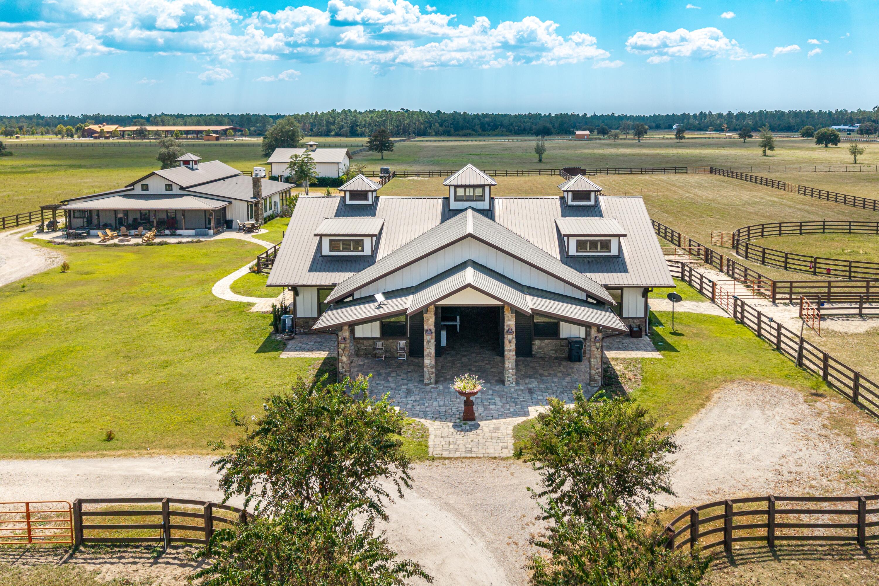 10.51 acres of Luxury Equestrian Living! Experience the perfect blend of modern luxury and country living at this fully renovated horse farm estate. With premium stable facilities, this property offers both refined living spaces and first-class equestrian amenities including 6 horse stalls.

Inside the main house, you will find 4,500 sqft of a fully renovated home in 2024 including 5 bedrooms, 5.5 baths, new wood flooring, high accent ceilings, and an open concept great room at the entrance. The gourmet kitchen features custom wooden cabinetry, granite countertops, and stainless steel appliances, making it both stylish and highly functional. Two spacious living rooms and a second kitchen provide for plenty of room for entertaining. This home comes fully furnished for a move-in-ready experience. 

Beyond the home, the estate offers upgraded stables, fenced and well-manicured pastures, and a rear storage shed for added convenience. The stable facilities remain in excellent condition and are well suited for horse care, training, and boarding. This turn-key deluxe equestrian setup is a horse lover's dream with each of the six stalls including double-rotating fans, automatic watering bowls, anti-fly misting system, and a covered paddock. There is a beautiful guest quarters attached to the stables including a third kitchen, full bathroom, and bedroom. There is also a separate wash area and tack area. 

Whether you are an avid equestrian or want a slice of luxury countryside close to the beach, this property is for you! Please call/text Taylor Simpson 850.333.2282 and/or Brooke O'Keefe 850.499.2031 to set up a showing today!