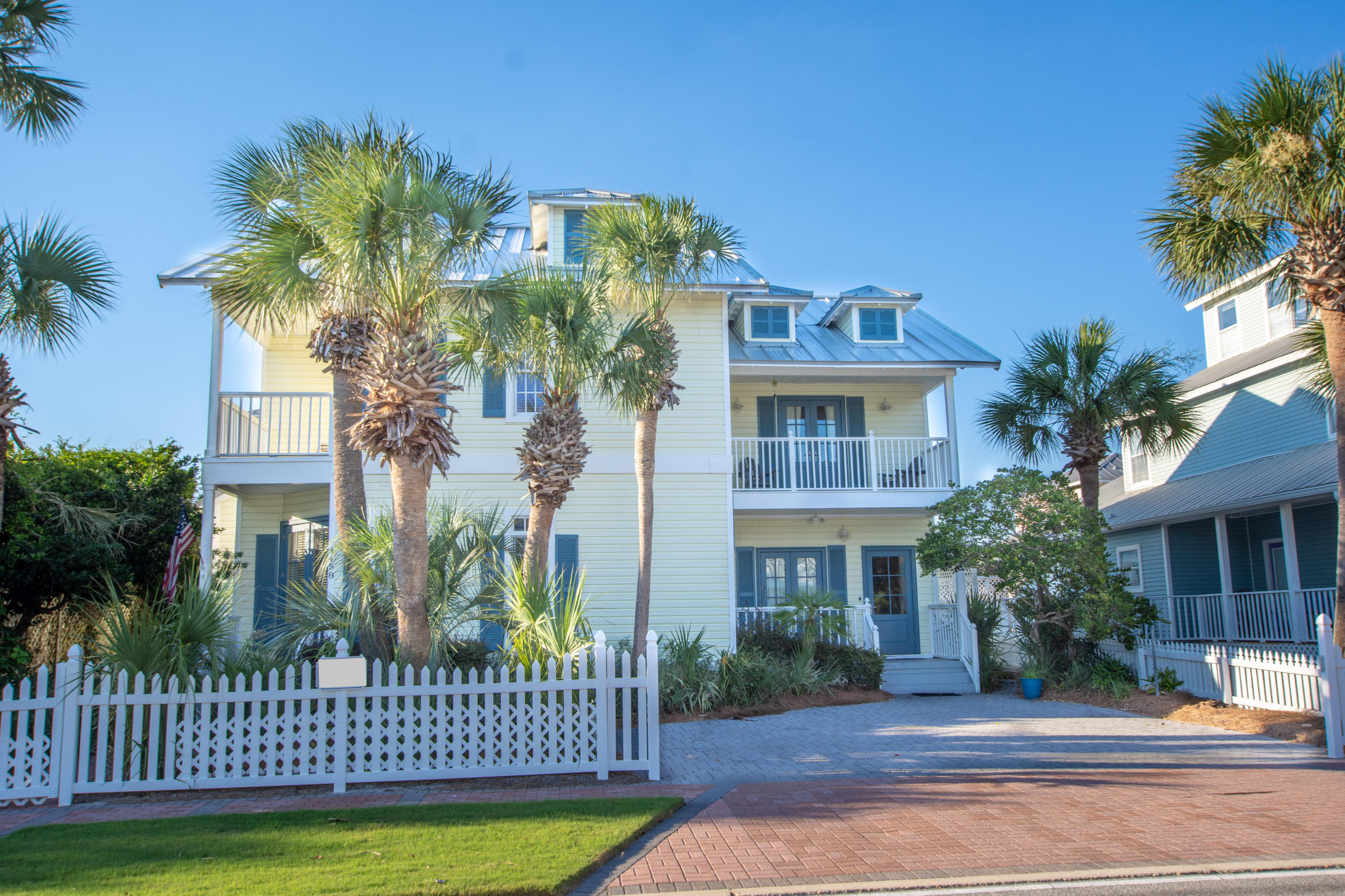 A quintessential beach house complete with a white picket fence located just ONE short block from the beach in famed Crystal Beach...which conjures of images of sun splashed days biking, swimming and walking to the beach. This meticulously maintained home features a unique floorplan that can be one large home, or operate as a lock-out with many ownership and rental possibilities for maximum income! The large and open main living area features beautiful travertine tile floors, a fireplace, built-in shelves and a beautifully renovated kitchen with stainless steel appliances and a large breakfast bar and dining area. An additional space on the main level could easily be converted to a bedroom suite or use as an office. Upstairs the master suite has 2 walk-in closets, his/her sinks and a balcony perched in the tropical landscape to enjoy the Gulf breeze.  In addition to the 2 guest bedrooms, the other side of the home features a kitchen, living area, bedroom, 1.5 baths and a bunkroom with loft! Just a hop, skip and a jump to the beach as well as the pool located right across the street!  The lush and tropically landscaped exterior and brick paver driveway completes the package...this home is a perfect residence, 2nd home or short/long term rental income producer.
