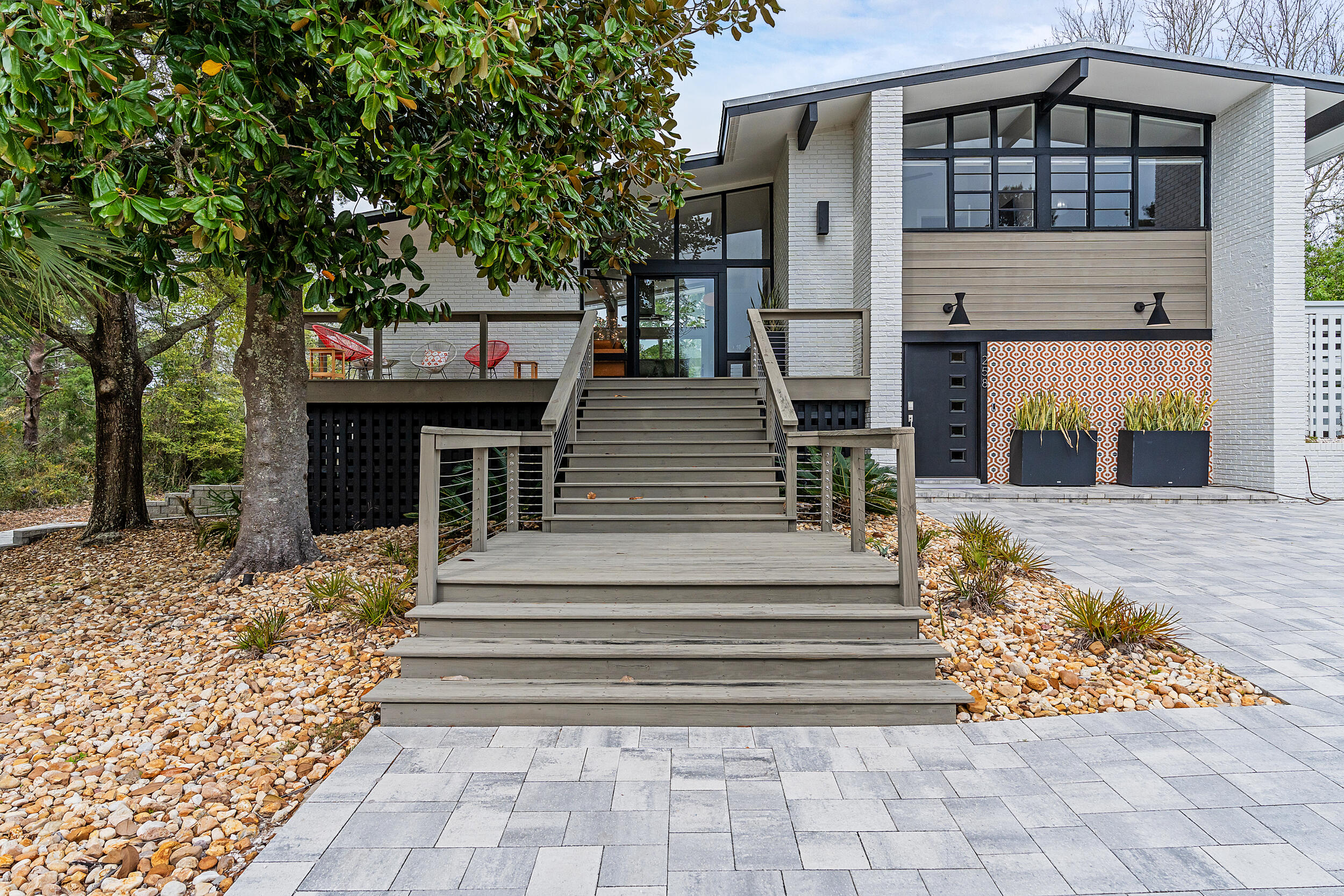 'Florida Flashback' - Built in textbook midcentury modern style in 1960, both the interior and exterior have undergone a complete transformation to embrace the original architecture with new-age design elements. Windows stretch from floor to ceiling keeping the home doused in Florida sunlight while the drool-worthy renovation boasts clean lines and pops of contemporary coastal decor. Both stylish and welcoming, the redesign of this home is flawless in execution. Encompassing 2,375 square feet, this home has five bedrooms, three and a half baths, over a half acre lot, private heated pool, over-sized one car garage, fully fenced in yard, and an Airstream as poolside décor for the ultimate retro-feel. Located in Dune Allen minutes from public beach access and the Santa Rosa Golf Club. NO HOA