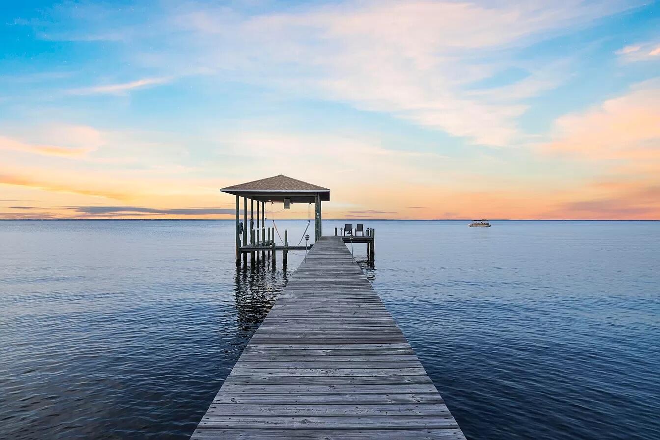 Bayfront Luxury + STR Ready 

 Wake up to dolphins dancing in the bay and end your days with golden hour views over the water! Welcome to 31 Bayshore Drive, a rare bayfront retreat in Miramar Beach offering direct water access, no HOA, and short-term rental approval with rental projections above $80,000.

Set on nearly half an acre of premium waterfront, this turnkey home comes fully furnished for immediate use as a high-performing short-term rental, second home, or full-time residence. All essential items: beds, couches, dining pieces, and some décor stay, with just a few select personal items excluded. Inside, the home is as functional as it is beautiful. The seller, a professional chef, intentionally prioritized a full butler's pantry over a traditional laundry room to accommodate the many family events hosted here, including Thanksgiving feasts and intimate family weddings. This isn't just a house; it's a place made for celebrating life and bringing people together.

From the moment you enter, you're met with expansive bay views that flood the home with light and create a peaceful connection to nature. The open-concept layout flows seamlessly from the chef's kitchen to the inviting living area and out to the back patio, ideal for entertaining or unwinding.

Big-ticket updates? Already done.

Roof replaced in 2020

HVAC and hot water heater replaced within the last 5 years

Saltwater-rated systems in place

Step outside to your private dock with boat lift and launch into the wide-open Choctawhatchee Bay. Spend the day cruising to Crab Island, paddleboarding at sunrise, or docking for dinner at Baytowne Wharf. And when the beach calls, the sugar-white sands of the Emerald Coast are just minutes away.

Looking for golf, shopping, or fine dining? You're only moments from Regatta Bay Golf & Yacht Club, Grand Boulevard, Silver Sands Premium Outlets, and Destin Commons  not to mention top-tier restaurants like Emeril's Coastal and Seagar's Prime Steaks & Seafood.

Whether you're seeking an income-producing rental, a coastal second home, or a primary residence with no compromises, 31 Bayshore Drive delivers the rare combination of waterfront access, beachside proximity, and luxurious freedom  all in a no-HOA neighborhood known for its privacy and charm.

Homes with private docks, rental approval, and this level of lifestyle access rarely hit the market  especially at this price.

 Don't let this rare coastal opportunity slip away. Schedule your private showing today and step into the Florida lifestyle you've been dreaming of.