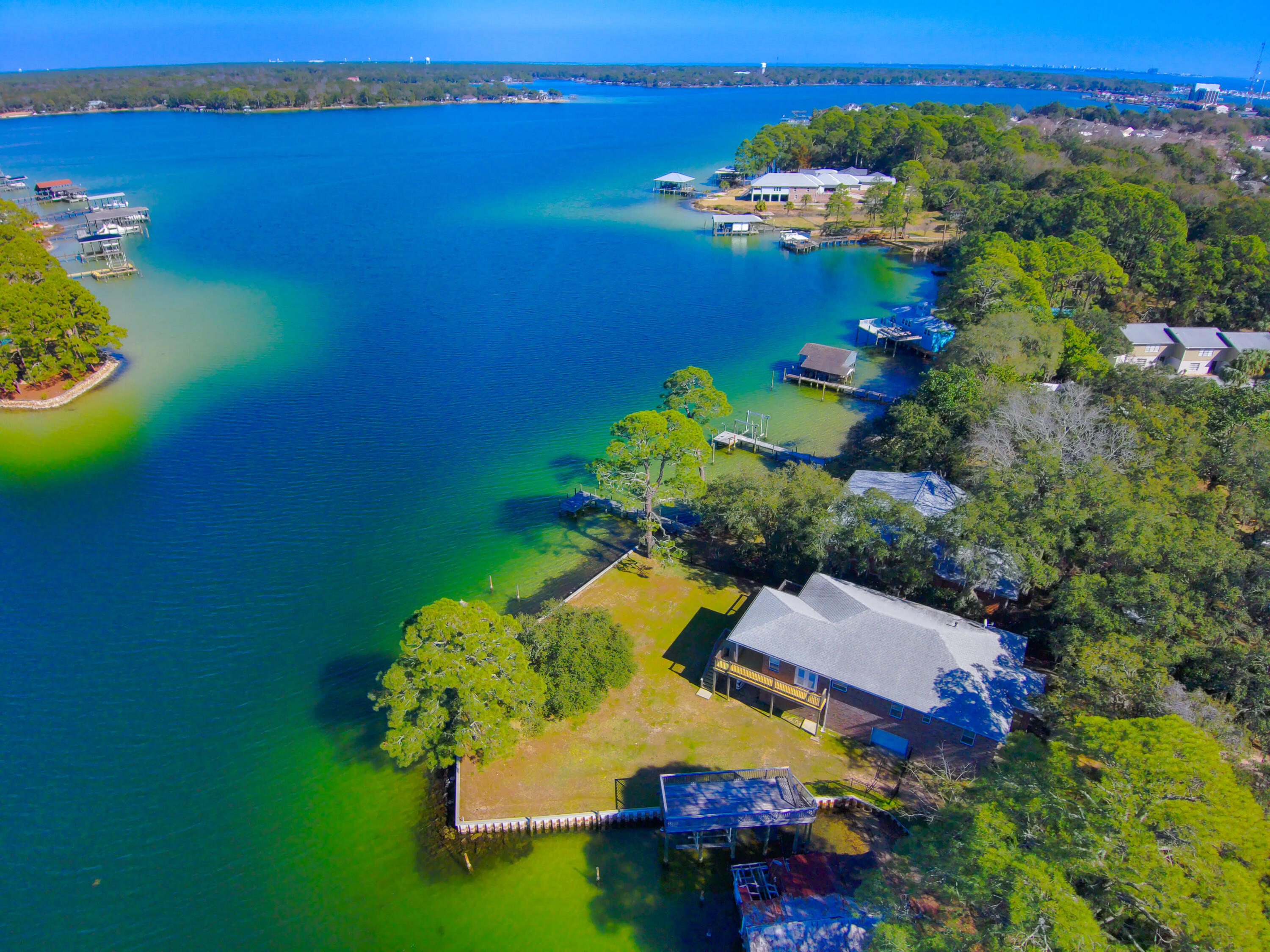 Breathtaking Waterfront Retreat with Two Docks & Panoramic Views!

Discover the ultimate waterfront lifestyle with this stunning property featuring over 200 feet of pristine waterfront and unobstructed panoramic views. Whether you're a boating enthusiast or simply love the tranquility of the water, this home offers two private docks, including a two-story dock with a boat lift and deep-water slips, perfect for large vessels or multiple watercraft.

Step inside to find a beautifully designed home with recessed lighting, rich hardwood floors, and elegant Tray ceilings. The open-concept layout seamlessly blends indoor and outdoor living, highlighted by four sliding glass doors that create a truly immersive experience. The kitchen is spacious, featuring granite countertops, stainless steel appliances, and a pantry with ample storage.
Located just minutes from Eglin and Hurlburt Air Force Base and only 10 minutes to the stunning waters of the Emerald Coast, this property offers both convenience and serenity. Perfect for paddleboarders, kayakers, and nature lovers, it provides direct access to our beautiful bays and bayous for endless water adventures.

Currently operating as a successful short-term rental, this property generated $90,602 in gross rental income in 2023 and $76,569 in 2024, making it an incredible investment opportunity. Property is being sold fully furnished with the right offer!

Whether you're looking for a luxurious primary residence, a vacation getaway, or a high-performing rental property, this waterfront gem is a rare find. Schedule your private showing today and experience the best of coastal living!