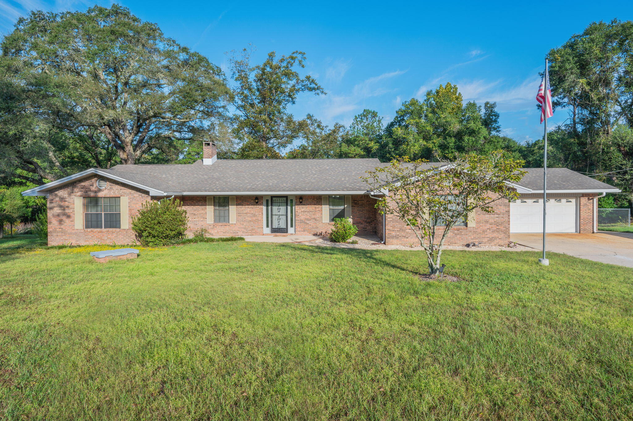 Experience the best of both worlds with this stunning all-brick 3-bedroom, 2-bath home offering peaceful country living just minutes from town! Enjoy county zoning with no city taxes on 4.65+/- beautiful acres surrounded by majestic oak and pecan trees. The property features a barn, workshop, covered storage areas, and even a crystal-clear pond stocked with bream and bass—perfect for relaxing afternoons or outdoor adventures.
Inside, you'll find a spacious living area centered around a cozy wood-burning fireplace, ideal for gathering with family and friends. The home includes a main kitchen and an additional canning kitchen in the laundry area for extra convenience. The master bedroom offers a garden tub, walk-in shower, and double vanity, providing a peaceful retreat. Step outside to the screened-in porch or open grilling porch overlooking the pondan ideal space for entertaining or enjoying quiet country sunsets. Recent upgrades include a new roof, hot water tank, and updated A/C system.
With plenty of space for your boat, RV, tools, and toys, this property combines rural charm, modern updates, and unmatched convenience. Don't miss the chance to make this slice of country paradise your home! Seller open to options! Buy the full property or a portion (minus barn & access road) at a reduced price. Great flexibility for buyers looking for land to fit their needs.