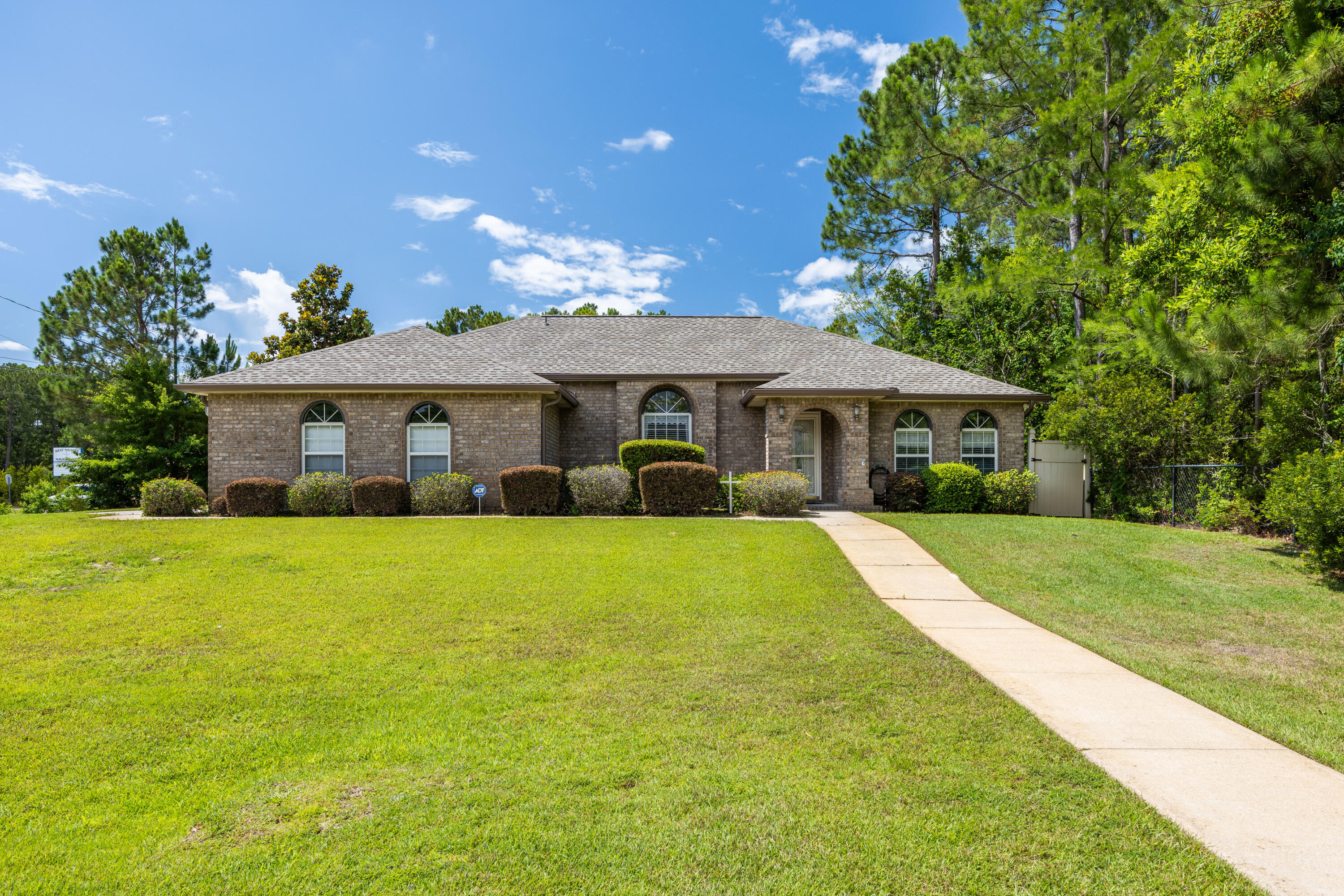 Custom built in 2006 by Fisher Homes, this beautiful one owner home has been meticulously cared for.  The 1,737 square foot home sits on an oversized .64-acre corner lot and is ideally located as it is close to local military bases, the sandy beaches of the Gulf Coast, and A rated schools. The bright and airy 3-bedroom 2-bath split-floor plan has tile and wood laminate floors throughout, custom wood cabinetry with granite counters, and spacious living and bedroom areas.  In addition, a flexible Florida room makes a great home office, gym, or playroom.  Outside, you will enjoy a large, fenced back yard with a storage shed for housing lawn equipment, bikes, and other outdoor games.  The home has a newly installed back fence, new garage door opener unit with controls, and newer roof (2024). Inside you will find plenty of closet and storage space. The home is also wired for surround sound with speakers throughout the house.  The seller has the original floor plans and has kept a termite contract in place since purchasing the home in 2006.  Storm protection panels for the windows are located in the shed.  In November 2025 the seller connected to public sewer.  The septic tank and field are no longer connected or functional.  
 
As a resident in one of Navarre's most desirable neighborhoods, Holley By-The-Sea, you'll enjoy membership in an impressive multi-million dollar recreational and clubhouse facility that includes: 3 pools, sauna and steam room, gym, tennis and pickleball courts, community room, playground, softball field, track, basketball courts, deeded access to Santa Rosa Sound with a private pier, boat/kayak launch, sandy beach, picnic pavilions, and RV parking.