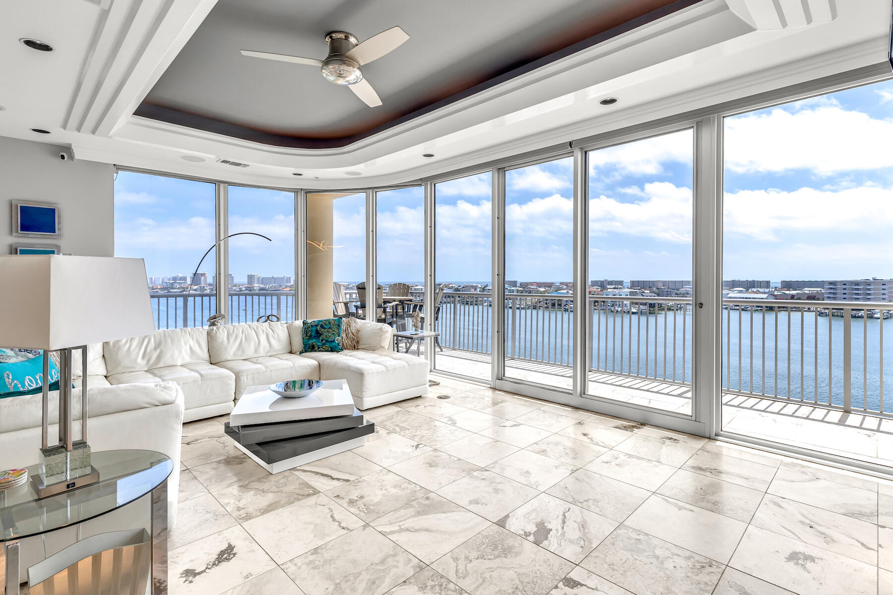 Come experience this contemporary three bedroom, three bath condo located right in the center of the Destin Harbor. With three balconies and floor-to-ceiling wraparound windows, this unit is a must-see for anyone looking for daily sunsets. The large wraparound 60-foot balcony provides spectacular views of the harbor, the Gulf of Mexico, and Destin's East Pass. This condo features an expansive, open floor plan with 2,265 sq. ft. all on one level. A custom spiral staircase leads to the private rooftop terrace with a summer kitchen and sunning deck...ideal for day or nighttime entertaining or simply relaxing in the privacy of your own rooftop space. Other interior features include lighted tray ceilings, custom cabinetry, marble floors in living areas, and engineered wood floors in the master bedroom. Both HVAC systems were upgraded to high-efficiency units in 2019. Destin Harbor Place is an exclusive five story waterfront condominium that offers the privacy and privilege of only 12 condominium residences, set amidst lush landscaping that enhances its coastal charm. 

There is a rental restriction for this building with no short-term rentals. Conveniently located on the harbor you are within walking distance from great dining locations including Marina Café, Beauchamp's, and Harbor Docks. You also may enjoy a water taxi ride that will pick you up on the private pier. Harbor Place amenities include private parking with 30 trellised parking spaces for the 12 units, gated entry to the building, an exercise room, a swimming pool, and a private dock with boat slips. This unit purchase includes a 50ft boat slip with a 10,000 lb. boat lift. There is also a paddle board/kayak storage hut along the harbor shoreline. Also included is an 8' x 10' secure storage space in the basement of the building, and a full-size, one-car garage with an automatic opener with an aluminum rolling door.