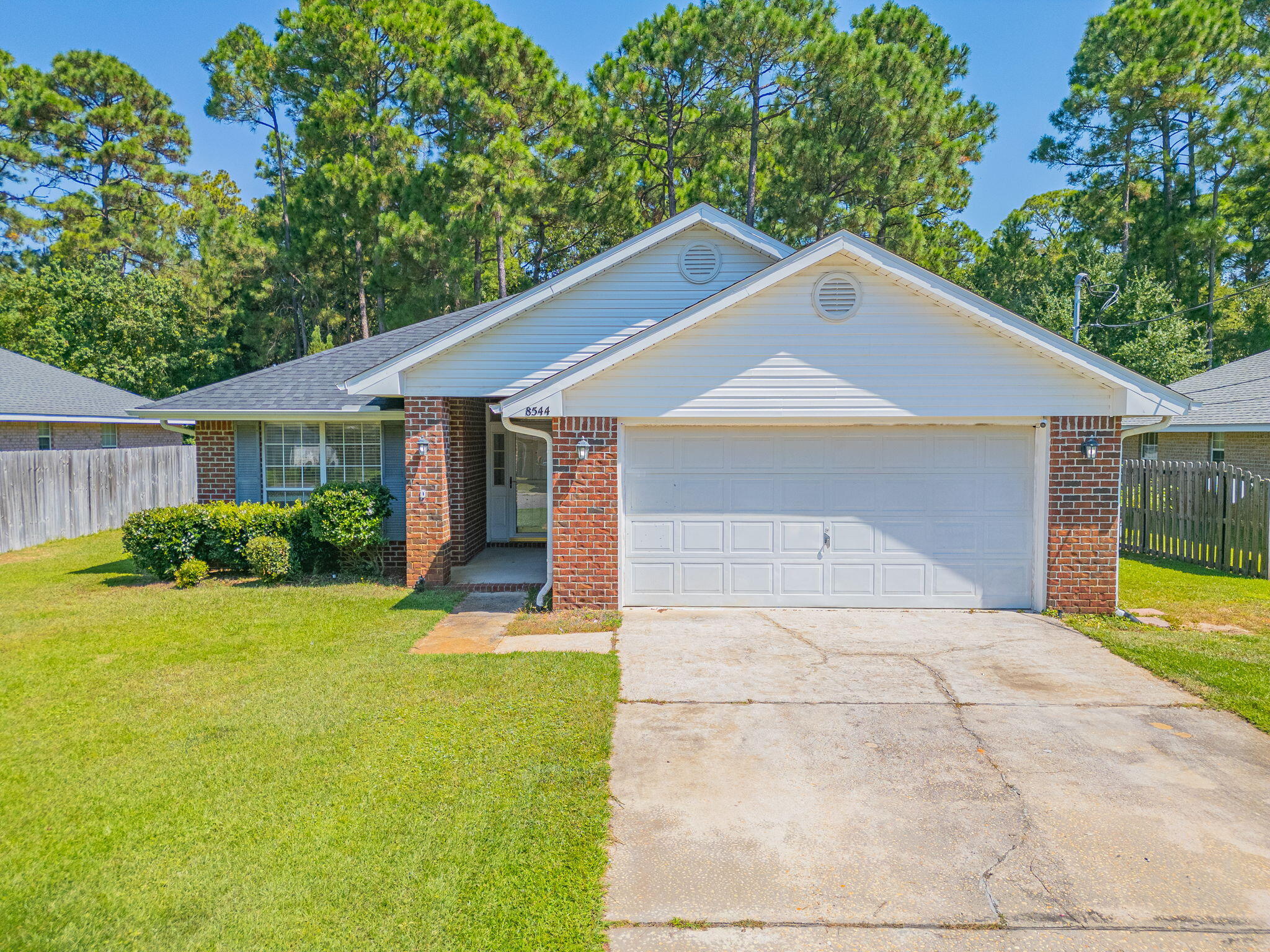 BEACH COMMUNITY OPPORTUNITY! Buy in Navarre! Great Primary or Secondary Home and/or Investment Property. No HOA!  All Brick 4 Bedroom Home on a Cul-De-Sac Street. This low maintenance home backs up to a wooded conservation area allowing for privacy. Within miles of the Navarre Beach Bridge. Navarre Library is a block away. Near Hwy 87 with easy access to I-10. All the Restaurants, Grocery Shopping and Necessities are within easy reach. Roof 2020 and HVAC 2024! NO CARPET! FRESH INTERIOR PAINT. This wonderful layout affords privacy for everyone. Eat-In Kitchen and a Dining Room. Large Family Room. Inside Laundry. 2 Car Garage to store Water Toys and Lawn Equipment. Both Covered and Open Back Patio areas for Grilling and Bird Watching. MUST SEE! Buyer to verify all pertinent info