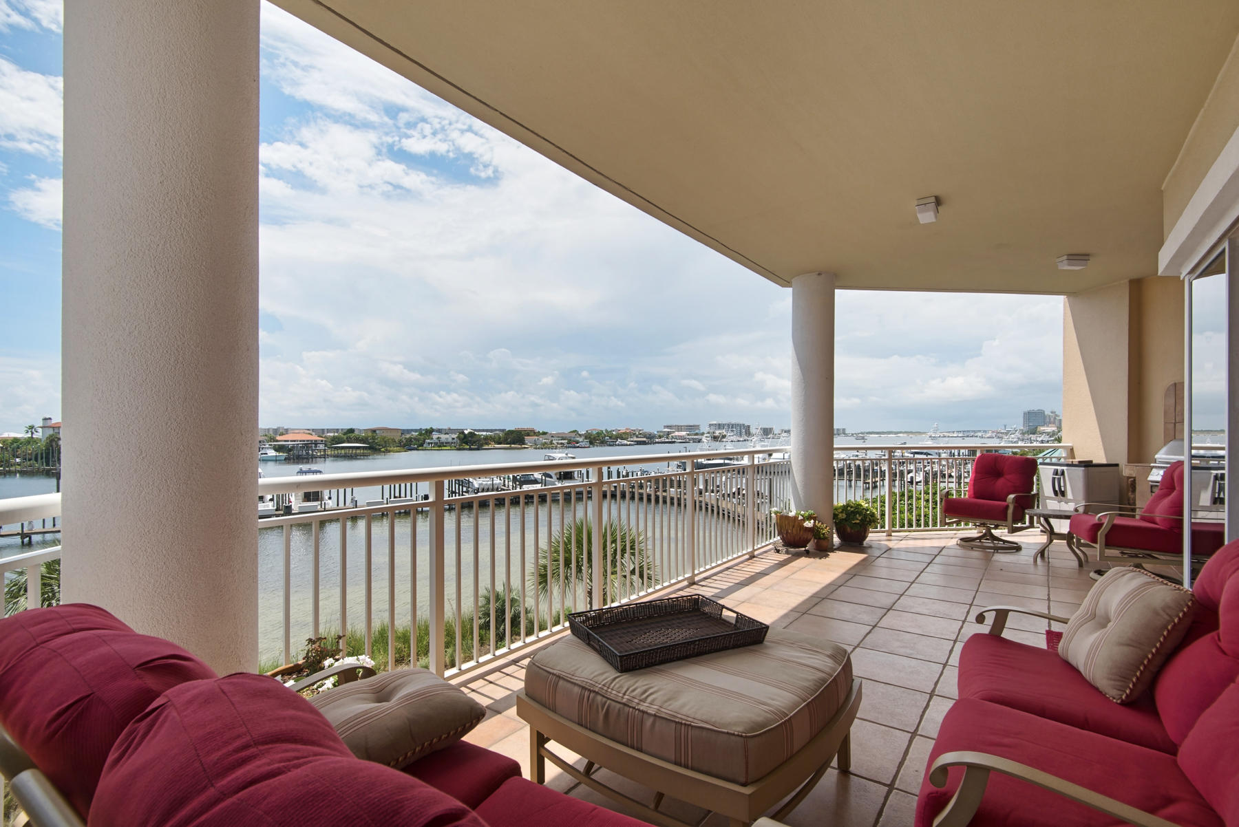 Majestic Sunsets and Tranquil Harbor Views await you in this 4-bedroom, 4-bath luxury condo in Central Destin. Grand Harbor is an exclusive, gated, rental-restricted condominium community that rests on the north side of the Destin Harbor with 47 units and 500 ft of water frontage. This first floor end unit is spectacular and one to be remembered. A travertine tile entrance invites you in to the open living space that reveals stunning Harbor views from the Living, Dining, Kitchen, Master and Guest Bedroom. This unique home sits on the east side of the condo with a sizable balcony hosting views of the Harbor, Holiday Isle, East Pass, Destin Bridge, Gulf of Mexico and Destin's famous afternoon sunsets. The master suite has two large walk-in closets, a walk in double headed shower, separate garden tub with jacuzzi jets and a double vanity sink. Three other large bedrooms with adjoining bathrooms ensure the same opulence for all. The kitchen is in the heart of the home and boasts granite counters, GE stainless appliances, a gas cooktop, pantry, trash compactor, double oven and lots of counter and eating spaces. A separate formal dining area is right off the kitchen. New paint, carpet, HVAC, and Water Heater add to the upgrades of the unit. The large feel of a home with the low maintenance benefits of a condo make Grand Harbor unique. This rental restricted condo's amenities include a heated swimming pool with Harbor Views, private marina and boardwalk, private guest suite for your visitors, community room, exercise room, under ground parking and a pet park.