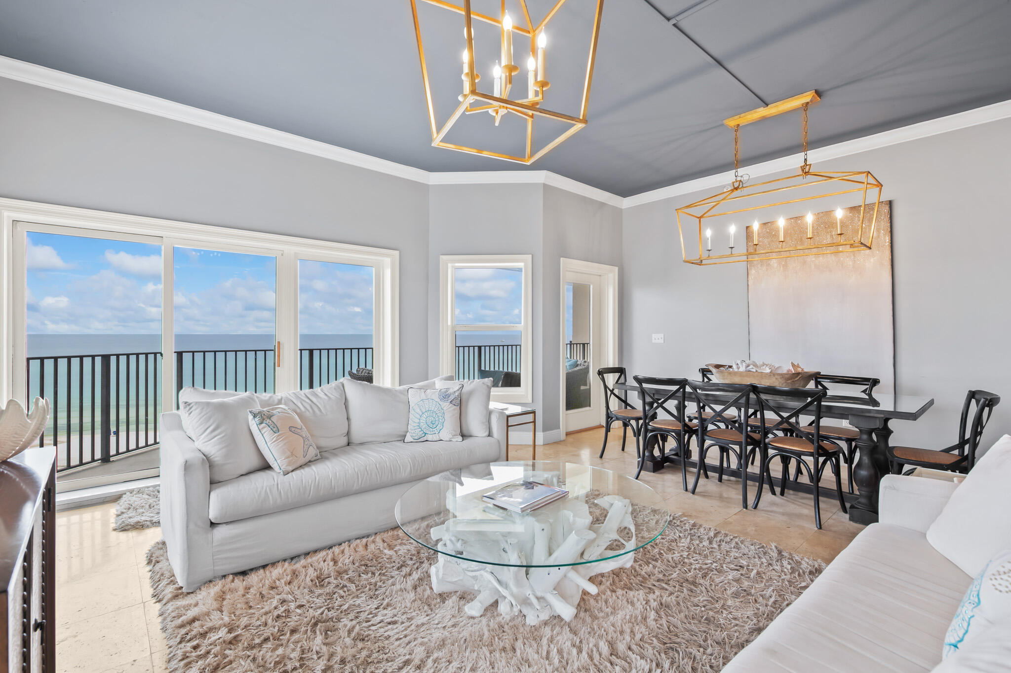 It's high-end coastal living at Seagrove Beach's The Legacy! This top floor, beachfront corner unit offers ultimate privacy from the rest of the world. Upon entry, you are greeted by its own foyer, leading up to the open living area. Relax in the spacious family room surrounded by ocean views, as well as the dining area, perfect for entertaining guests. Indulge yourself in the updated eat-in kitchen equipped with a kitchen island and stainless steel appliances. Soak in the flood of natural light while enjoying a glass of your favorite bottle from the wet bar. The main bedroom offers dual vanities, walk-in shower, private water closet, and drop-in bathtub, and an oversized balcony to delight yourself in the sun without leaving the comfort of your condominium. The rest of the 2,290-SF unit (sleeps 10) is completed with 3 additional guest bedrooms, one of which can be used as a second master bedroom with it's on en suite bathroom.  This unit offers  plenty of storage and laundry facility. Indulge in exclusive amenities within the gated development, including a communal pool overlooking the Gulf, a biking path, parking facility, and private, deeded beach access monitored by the Homeowners Association. Don't miss your chance for this sought-after residence located in the heart of Seagrove. Reside minutes away from shopping, dining, and the best hotspots on 30A!