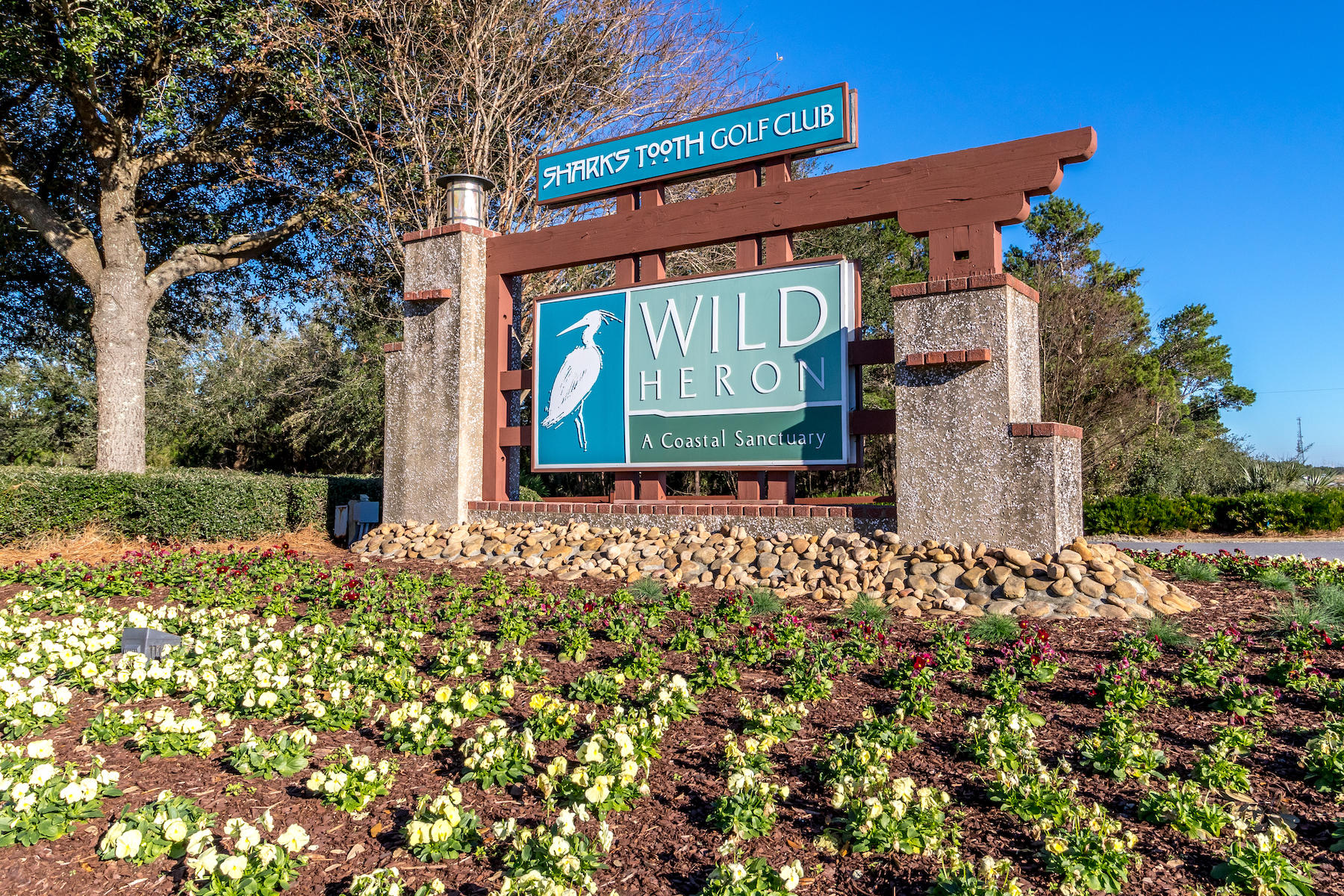 Beautiful, oversized lot, which backs up to a fairway of Shark's Tooth Golf Course, within the coastal community of Wild Heron. The gated Wild Heron community is located along the shores of Lake Powell, one of the region's largest coastal dune lakes. Endless amenities in Wild Heron, including Shark's Tooth Golf Club Course, driving range, tennis courts, trails, swimming pool, fitness room and boat house.