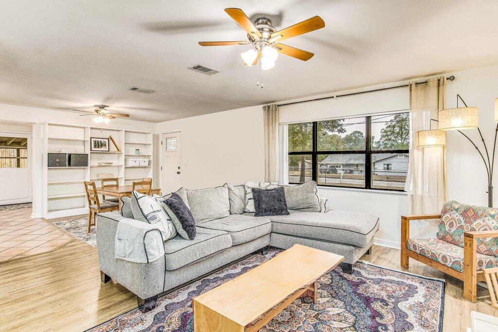 Back on the Market at NO FAULT of the Sellers.  Welcome home! Upon entry, you'll love the open concept. Enjoy the large living room with plenty of natural light and wood burning fireplace, updated kitchen with granite and stainless-steel appliances, three nicely sized bedrooms, interior laundry, large mudroom/bonus room plus a bonus 100x100 powered workshop. Set up your outdoor furniture on the newer open deck, perfect for BBQ's, relaxation, or entertaining in your private and fully fenced backyard. What a perfect home!  Newer Roof -2021, Newer LVP floor and tile in wet areas- 2021, new interior paint, new front door, new storm door, popcorn ceiling removed, new fixtures and new plumbing throughout entire home to the street. Located in the heart of Valparaiso, this home, surrounded by trees, is nestled on a quiet street just a stone's throw from Lincoln Park, Glen Argyle Park, Valparaiso Fishing Pier, Tom's Bayou, the East gate of Eglin AFB, the Heritage Museum AND a just short drive to the beautiful beaches of the Emerald coast and the BEST shopping anyone could ask for. It's the perfect location to enjoy all the area has to offer.  Don't wait! Schedule your private showing today!