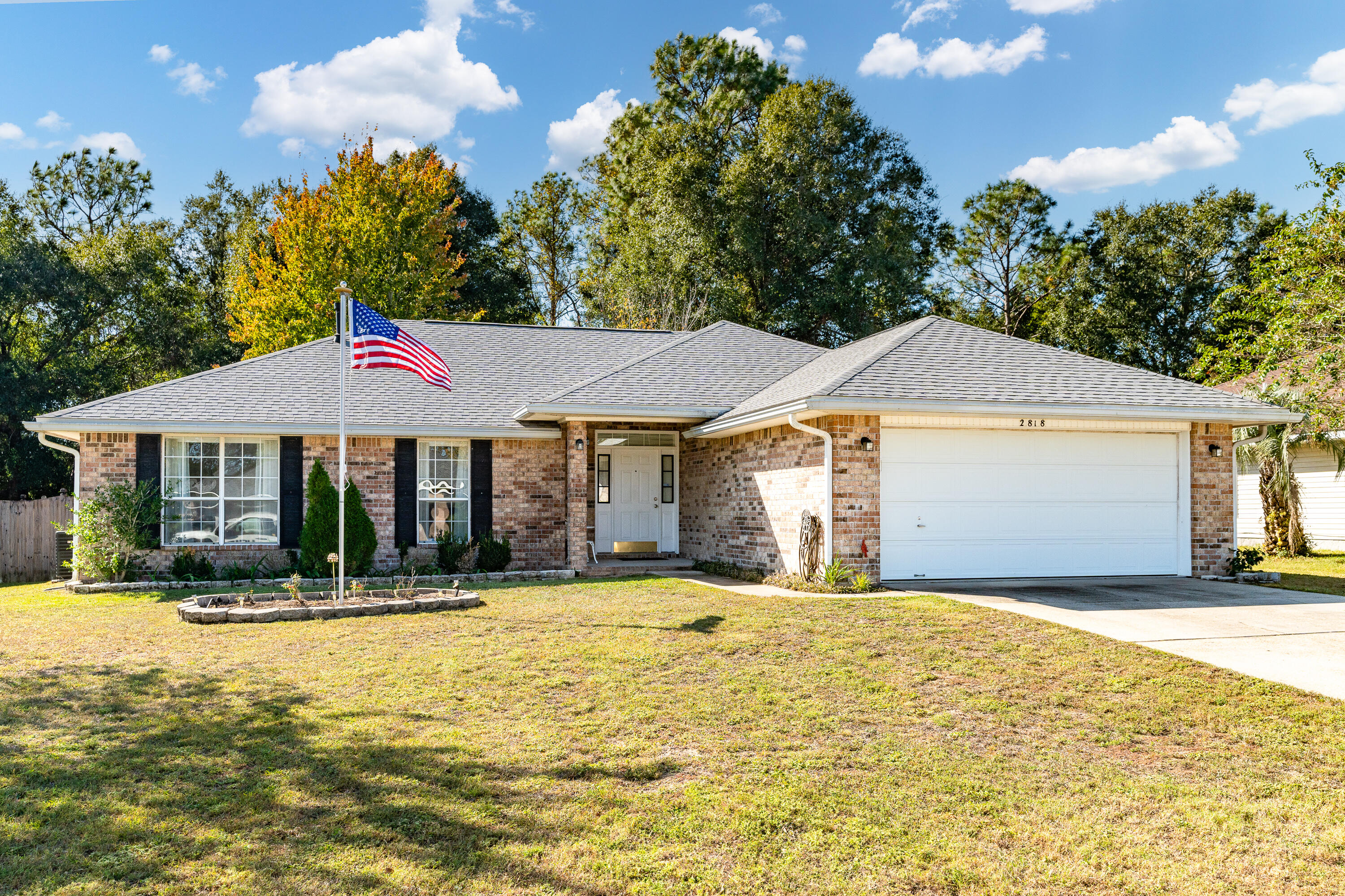 Welcome to 2818 Atoka Trail!  Come inside this well-designed home located just south of I-10.  This location is perfect for a quick commute to local bases and beaches.  Step inside to discover vaulted ceilings and large windows that enhances the open feel, seamlessly connecting the living room, dining area and kitchen. 
A versatile 4th bedroom or study is conveniently located off the foyer, perfect for guests or a home office.
You will find plenty of counterspace in the well-appointed kitchen complete with a gas range, making it a dream for the home chef!  The split floor plan enhances privacy. Retreat to the master suite complete with a large double vanity, walk-in closet and linen closet in the spacious master bath.
The remaining two bedrooms are ample in size with convenient access to the tastefully updated full bath.
Enjoy your mornings or unwind in the evenings on the screened in porch, overlooking a large, flat backyard that offers plenty of room for outdoor activities.  With protected wooded green space directly behind the home, you will appreciate the added privacy. And bonus...this home also comes with its own security system.  Don't miss this opportunity to make this property your home...Make an offer today!