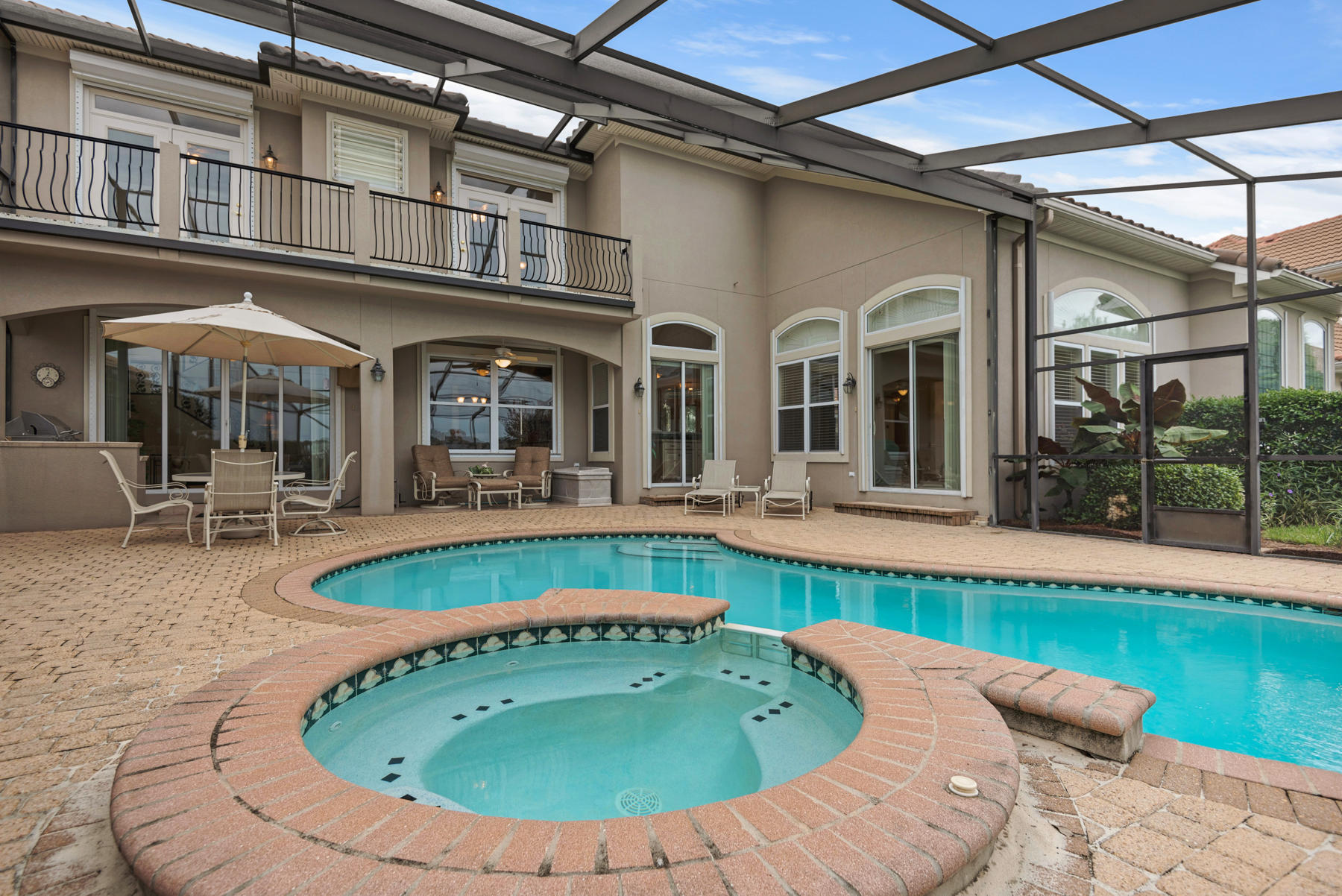 Meticulously Maintained Lakefront Home with Private Pool, Gulf Views, and First-Floor Master Suite in Gated Destiny East. The two-story, covered lanai with pool, spa, and grilling area offers stunning views of the lake. Unique to this home, a striking porte-cochere announces the entry. Large windows and an open floor plan allow natural light and views of the lake to reach deep within the interior. The formal dining room, breakfast area, sitting area, and family room on the first floor are accessible to the pool. The wet bar is perfect for entertaining. The well-equipped kitchen with paneled refrigerator, range hood, and gas cooktop offers views of the lake. The first-floor master suite offers lake views, a fireplace, a sitting area, a renovated en suite, and direct access to the pool. The master en suite features double vanities, garden tub, shower with multiple body sprays, and walk-in closet. A guest suite completes the first floor. Two guest suites on the second floor open to the balcony overlooking the lake. The loft area is ideal for an office, gym, or sitting area. Pristine landscaping frames this immaculate home featuring hurricane shutters, 3M shatterproof security film on all windows. This home would be a perfect full-time residence or investment property. Destiny East features deluxe amenities including a gated entry; clubhouse with gym, theater, and party room; two lighted tennis courts; two community pools; spa, and playground. Destiny East is just a short golf cart ride to the beach and close to Destin's favorite restaurants, shopping, golf courses, and water sports. Make your appointment today to tour this beautiful home!