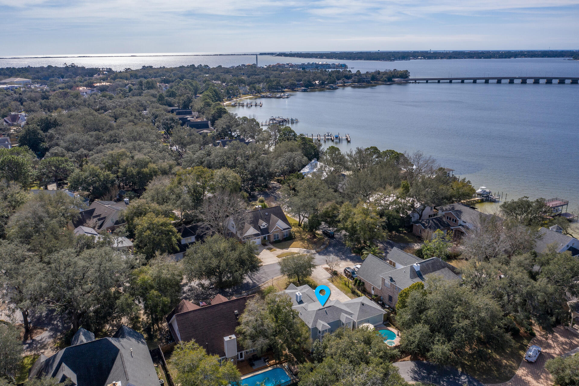 LIVE THE WATERFRONT LIFESTYLE w/ DEEDED COMMUNITY ACCESS TO GARNIERS BAYOU WITHOUT THE WATERFRONT PRICE. Spectacular 3 Bedroom, 2 1/2 Bath, 2 Car Garage Home with POOL & SPA. This remarkable home is tucked away on an oak lined private drive in the quaint community of Palm Shores. Palm Shores offers its residence a community park with deeded access to Garniers Bayou & the bay. Start your day launching your PADDLE BOARDS, CANOES, OR KAYAK directly from the community park. Then come home and relax & unwind in your private salt water POOL & SPA & end your day connecting with friends on your back patio. The pool & spa are heated for year around fun! Rarely does an opportunity come available to acquire a home in this premier community. The southern coastal charm of the architecture & (READ MORE) the calming coastal color palette & expansive wrap around front porch & deck add character to this unique home. From the moment you walk through the front door you feel at home! The light, airy living space with high ceiling is brightened by four sets of french doors that open onto the front porch. The gas fire place offers a warm place to relax during the cooler winters. The home has a very functional floor plan with an open concept, while maintaining designated spaces. You will love the wood floors throughout the home, with the exception of tile in the bathrooms & laundry room. The kitchen offers all stainless steal appliances to include a gas range, french door refrigerator, dishwasher, & microwave. There are ample cabinets, expansive counter space, double sink, & separate prep sink that make this kitchen a chef's dream! There is also a wood top bar that extends into the living area and adds to the character of the home. The kitchen also features a dining nook. Off the kitchen is a perfect bonus space that can be made private with a pocket door & glass door off of the living area. This room would make the perfect home office or formal dining room. The Master Bedroom is tucked away on the 1st floor offering ample privacy from the guest bedrooms on the 2nd floor. The Master Suite is spacious with a large walk-in closet and updated Master Bathroom. The Master Bath features a large garden tub, separate walk-in shower, & granite top vanity. The Master Suite is enhanced by its access to a private back deck overlooking the sparkling pool. This is the perfect place to enjoy a cup of coffee in the morning or a glass of wine in the evening. The laundry room is conveniently located on the 1st floor & is a large multifunctional space with extra storage and a 1/2 bath. The 2nd floor features 2 additional Guest Bedrooms with ample closet space & each bedroom has its own private balconies. Centered between these bedrooms is the Guest Bathroom with large garden Tub / Shower. For added peace of mind, the exterior of the home was complete painted in 2019, the roof & gas hot water heater are only 8 years old, the pool has been updated in the last 1+ year with a new gas heater, new pool pumps, & new sand filter. To add to the FLORIDA LIFESTYLE, the home is located within 1 mile of Shalimar Yacht Basin & Marina. The home is also located 0.3 miles from Meigs Middle School & 1 mile to Shalimar Elementary School. DON'T Miss Your Opportunity to Call this wonderful place HOME! Call your Realtor Today!