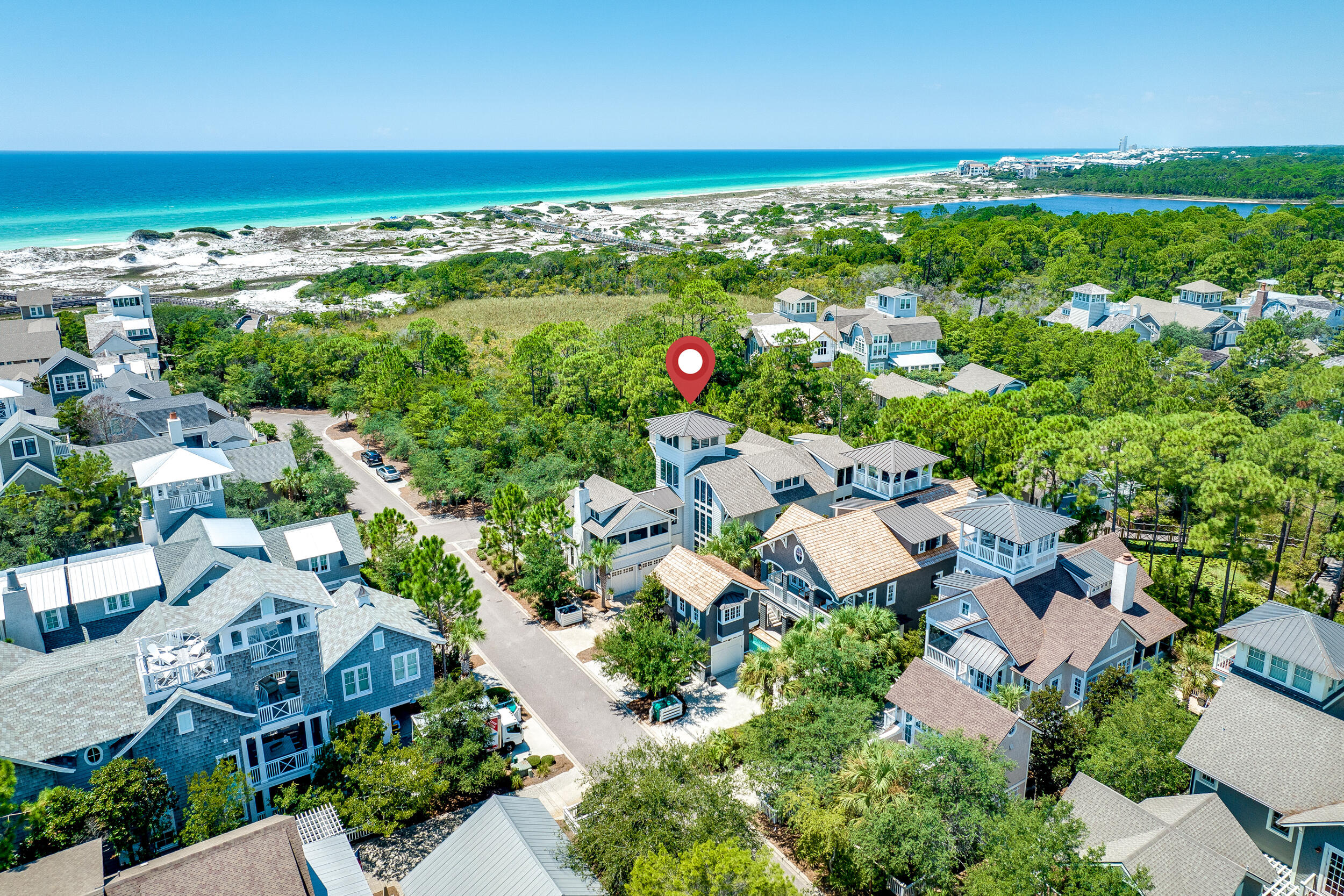 Introducing a captivating residence nestled on a corner lot mere moments from the beach & golf path. This estate boasts a safeguarded conservation area to its south, maximizing privacy & curtailing future development. It features one of Watersound's largest pools —a saltwater oasis, with hot tub, tanning shelf & privacy fence. Outdoor living space is accompanied by a gas firepit. The lush landscaping lends an aura of seclusion. The kitchen boasts superior first-class appliances, & an airy, luminous walk-in pantry serves as storage & bar room. The adjoining dining area seamlessly transitions into the inviting living space, anchored by a gas fireplace. Off the great room lies the screened porch, an idyllic spot for relaxation. A primary suite awaits on the ground floor, complete with an en-