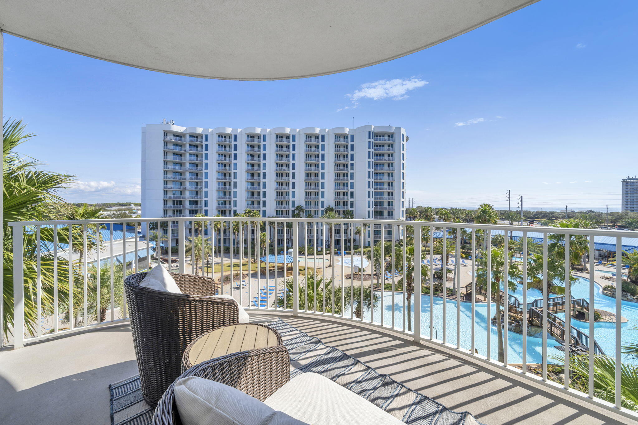 This beautifully furnished junior suite showcases tranquil views of swaying palm trees, the stunning pool deck, and even a glimpse of the Gulf of America. Ideal as a primary residence, vacation getaway, or income-producing investment, this property truly checks every box.

The open-concept interior features granite countertops, maple cabinetry, a breakfast bar, and newer appliances--including a washer, dryer, and dishwasher. Both the living and dining areas, along with the spacious primary suite, offer direct access to a private balcony--perfect for unwinding while enjoying breathtaking sunset views.

Resort-style amenities surround you with tropical landscaping, a lagoon-style pool, heated pool, kiddie pool, and hot tub--all just steps from your door. Additionally, the complex has a fitness center, and tennis courts. Electric vehicle charging stations also available. The Homeowner Association (HOA) fees cover all utilities, phone, cable, wifi, and security. The location is close to Gulf beaches, golf courses, fishing spots, shopping centers, a water park, restaurants, and the airport. Schedule your showing today!