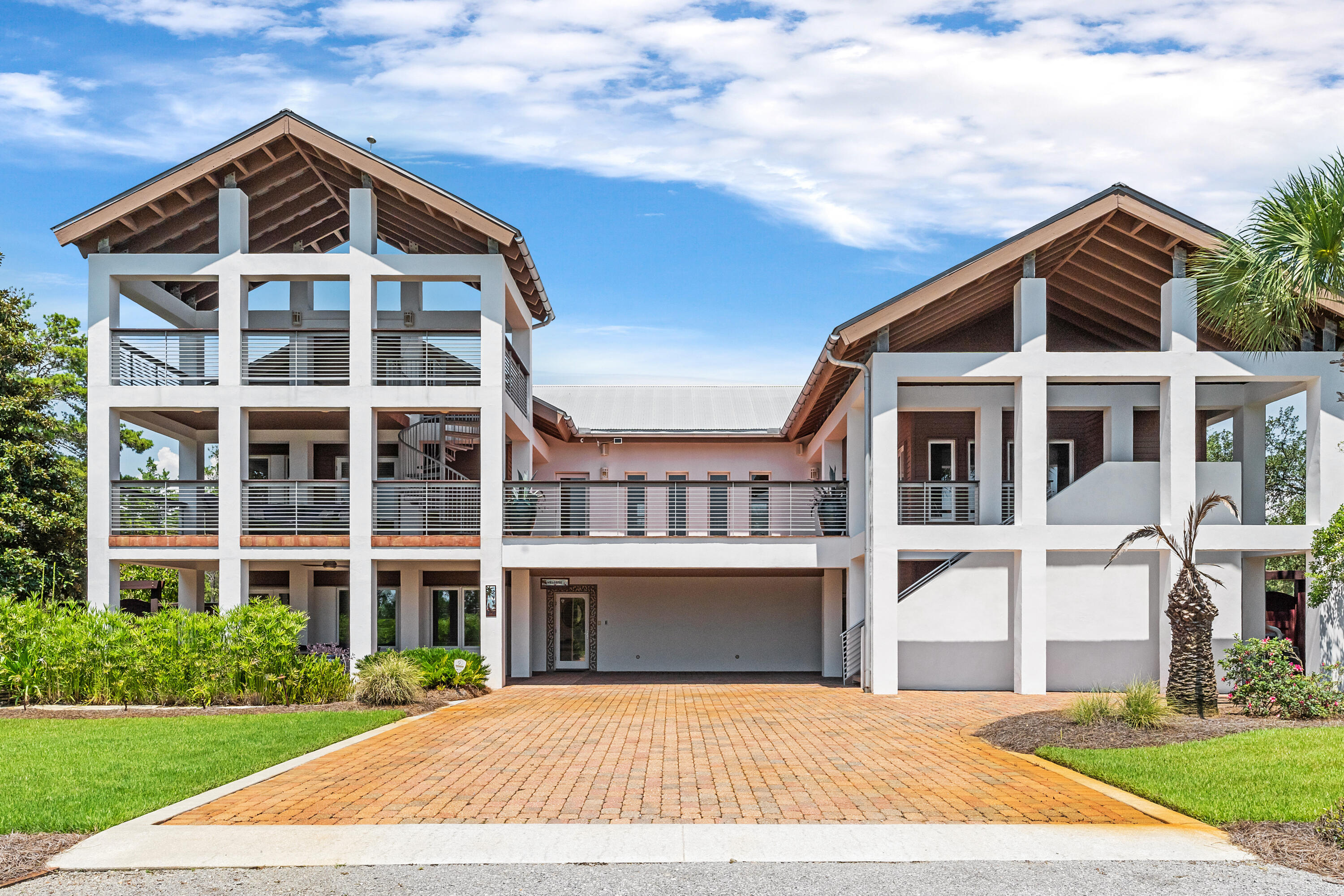 Huge price improvement! This stunning custom-built home is situated on a spacious third-acre lot south of the west end of 30A, offering breathtaking Gulf views and an enviable location across the street from Topsail Preserve State Park. With just over 4,000 sq. ft., this magnificent residence combines luxury, comfort, and exceptional craftsmanship. Dive into the large, sparkling, heated pool or host gatherings around the summer kitchen. Enjoy the warmth of an outdoor fireplace in the Fall and Winter. The landscaped yard also features a serene koi pond, creating a perfect ambiance for outdoor enjoyment. The oversized balcony and additional ''crows nest'' provide panoramic Gulf views, making it an ideal spot to watch the sunset. Just a golf cart or bike ride away to the beach.