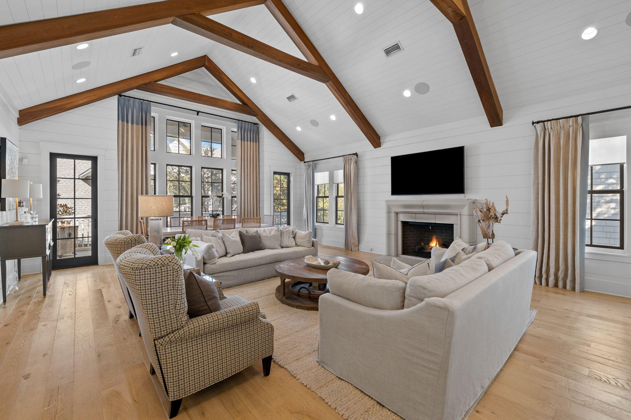This fully furnished, Nantucket-style masterpiece is located in the highly desired gated neighborhood of Watersound Beach.  This magnificent 3 level home with an elevator offers impeccable design & quality finishes throughout. The main home includes 4 bedrooms and 6 baths w/a 5th bedroom & apartment w/a full bathroom located above the garage in the carriage house.  The bright open floor plan is professionally decorated with high-end furnishings and custom window treatments. The home has white oak flooring throughout, a gracious living area with vaulted ceilings & gas fireplace. The chef kitchen has an expansive island w/quartzite countertops & Thermador stainless steel appliances.  The home has two primary bedrooms w/ensuite baths and spacious walk-in closets. The bunkroom home is located off of a separate family room allowing for entertaining of friends. The home has four separate porches with a heated pool & water feature to enhance ultimate relaxation. The rental rate includes the following fees:  HOA/Pool Maintenance/Landscaping/Internet/Cable.  Rental includes all utilities, pool and yard maintenance.