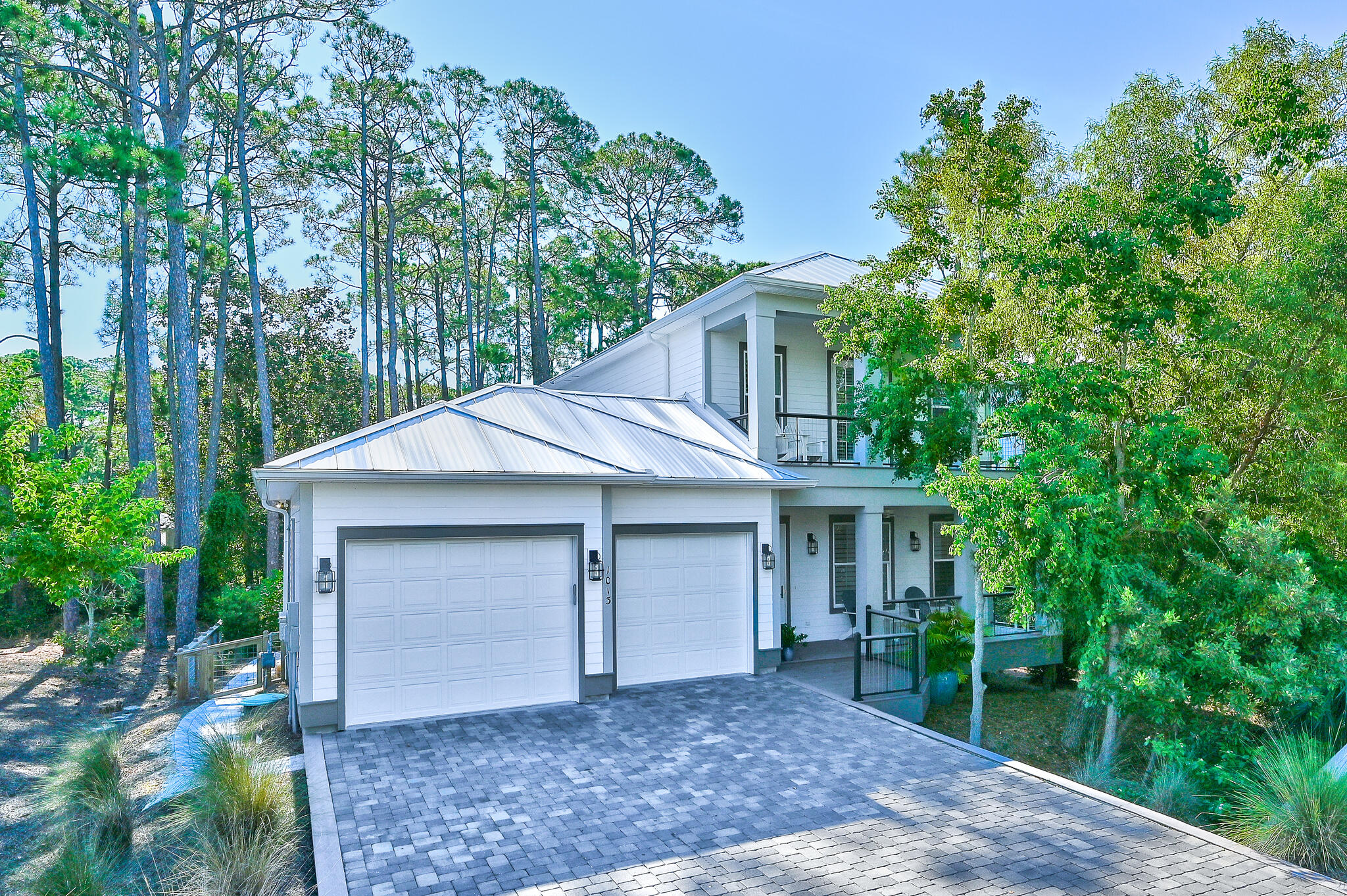 Rare opportunity to own this 4 bedroom, 5 bath,  2 car garage high end home just steps to the Dune Allen Beach access. This home features an open concept living plan with first floor primary bedroom, ensuite bath and large walk-in closet. Kitchen features gourmet stainless appliances and granite countertop. A wet bar has an icemaker. Spacious dining area and the primary bedroom opens to a secluded screened in porch.  The second floor has another primary master ensuite which opens to a covered deck.  There are two other ensuites bedrooms each with walk in closets. This home offers outdoor living at it's best! Enjoy the masonary, wood burning fireplace or settle into the wonderful hot tub while listening to your favorite music. The outdoor living space also boast all Blaze Professional Marine Grade grill and side burner.  The kitchen area also has a Blaze Marine grade refrigerator and a Primo Kamdo smoker.  The kitchen area is appointed with granite counter top full sink and marine grade exterior cabinetry.