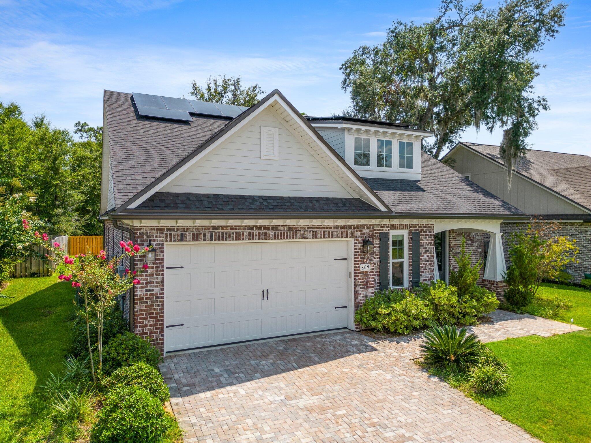 Come see this gorgeous custom built home today! If you need plenty of space this one's for you. It's rare to find a 5 bedroom, 4 bath home plus an office that could be used as a sixth bedroom, exercise room , craft room - the possibilities are endless. Built in 2020 the kitchen is a chef's dream with warm wood cabinets and durable quartz countertops accented with beautiful glass subway tile backsplash. You'll enjoy the five burner stainless steel gas cooktop, wall oven plus microwave and high end side-by-side refrigerator. The breakfast bar is the perfect spot for a quick bite to eat or you can use the dining area which overlooks the screened porch and partially fenced backyard. The large first floor master bedroom has a sitting area as well as walk in closet and en suite master bath  featuring a whirlpool tub, oversized tile shower with 3 rain shower heads plus a handheld and you'll never have to worry about running out of hot water with a Rinnai tankless hot water heater. Double sinks and a dedicated vanity area and premium lighting complete your own personal space. Don't miss the opportunity to occupy this stunning, spacious home! Call for your showing today!!!