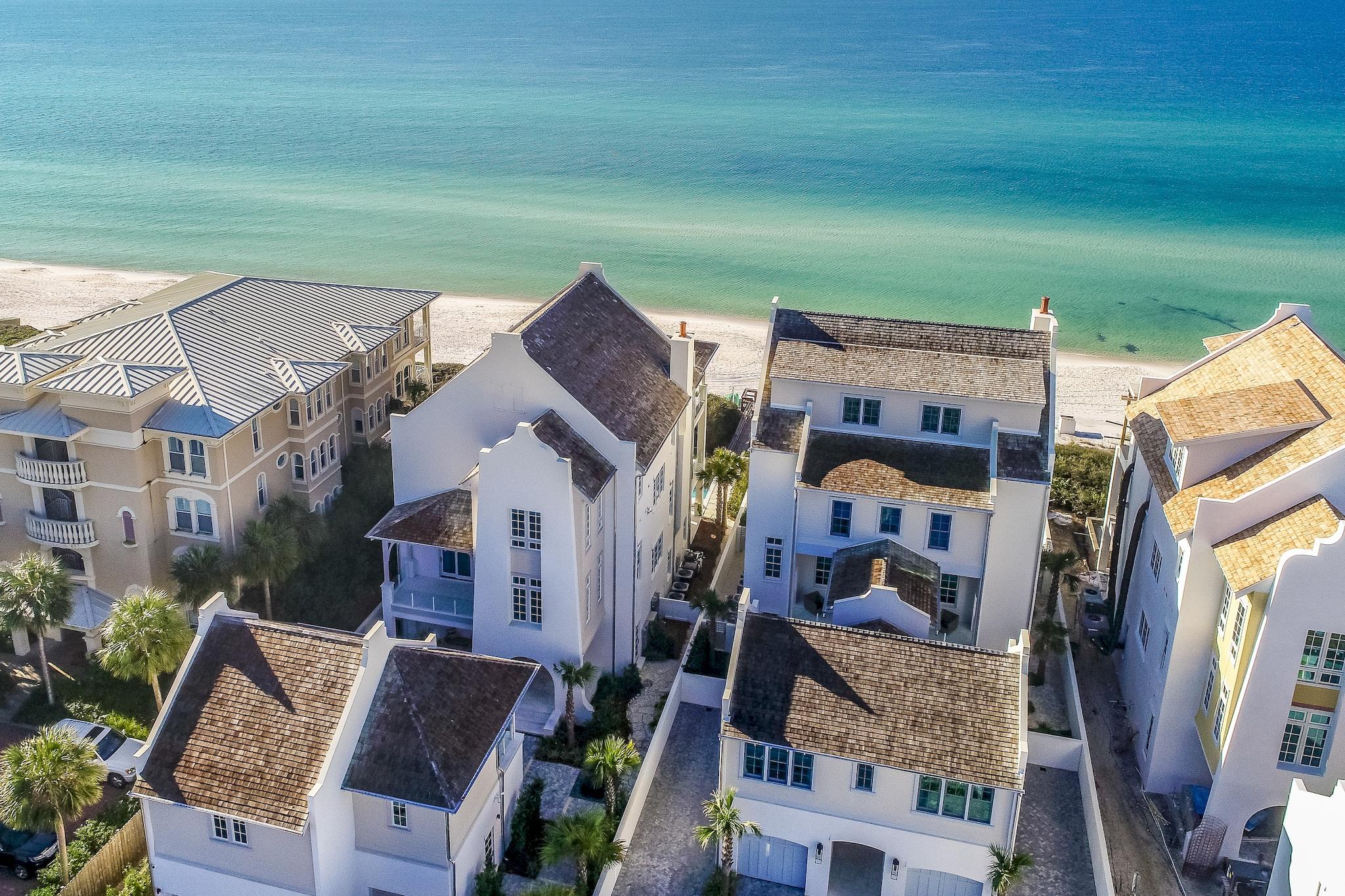 Reigning on 60' of Gulf frontage atop the Bluffs at Sandy Shores, this iconic estate affords unprecedented coastal living. The low-density gated enclave of residences is prominently situated between Rosemary Beach and Alys Beach along 30A in Northwest Florida. Curated by the world-renowned team at Chancey Design Partners, this one-of-a-kind manor showcases a coastal design vision brought to life with the highest quality materials and finishes.

Overlooking one of the most sought-after beaches in the US, the breath-taking views of the sugar white sands and the emerald green hued waters can be enjoyed throughout all three levels of the home. Concrete fortified construction paired with exquisite design creates an unparalleled experience of seaside living. The immaculate and stately presence is appreciated upon initial approach. The front elevation is moored by a courtyard bordered with lush landscaping and a serene water feature connecting the outdoors to both the main home and carriage house. Upon entry, visitors are greeted by the grand foyer. Views of the water immediately attract attention as you travel through the foyer and into the recreational room which leads to the outdoor oasis. The thoughtfully configured outdoor living area showcases a private pool, spa, fully equipped summer kitchen, an abundance of porch space, and a private beach walkover with access to the expansive beach frontage. An oversized bunk room with en-suite and pool bath complete the first floor.

The striking stairwell provides ample natural light which highlights the tumbled white stone paver flooring while granting access to the main level of the estate. The chef's kitchen is situated on the eastern end of the great room. Marble countertops, luxury gas range, built-in refrigeration, dual sinks, sprawling island and a spacious dining space complete the kitchen. The living space is anchored by a grand fireplace and wood adorned ceilings. A spacious keeping room and powder bathroom are found off the great room in addition to a guest suite.

The third level is home to a sprawling main suite with a sizeable living area, sleeping quarters, closet, and dual ensuite bathrooms. Two additional guest suites and a wet bar complete the third level.

This Sandy Shores villa epitomizes the luxury lifestyle of 30A while still being geographically poised minutes from the surrounding new urbanism communities like Seaside, Watercolor, Alys Beach and Rosemary Beach. Inquire today and start living the coastal lifestyle you deserve.