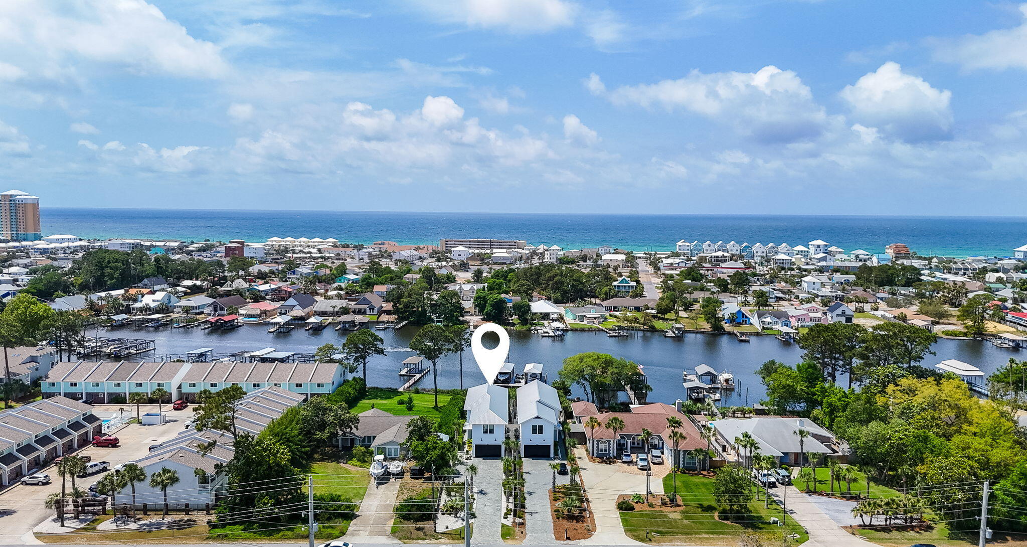 Experience the ultimate boater's lifestyle on Grand Lagoon in Panama City Beach, where this beautifully furnished 4-bedroom, 3.5-bath waterfront home offers deep water access and a private dock with lift just minutes from the Gulf of Mexico and Shell Island.

Designed for those who love life on the water, the property features a 14' x 40' covered boathouse and a 16,000-lb boat lift, making it effortless to spend the day cruising, fishing, or enjoying waterfront dining throughout the area.

Inside, the 2,800-square-foot residence offers spacious living areas ideal for hosting family and friends. The open layout flows seamlessly to the outdoor living spaces, where spectacular lagoon views create a stunning backdrop for everyday living and entertaining.

Step outside to your private backyard retreat featuring a heated saltwater pool, firepit area, and fully fenced yard - perfect for gatherings, sunset evenings, or relaxing after a day on the water.  This newer home also includes lush landscaping, a two-car garage with ample parking, offering both functionality and comfort for full-time living, luxurious coastal getaway or vacation rental property. Ideally located near local marinas, waterfront restaurants, shopping, and Northwest Florida Beaches International Airport (ECP), this home combines convenience with one of the most sought-after boating locations in PC Beach. The 2023 Regal Boat with twin Yamaha 300 outboards, approx 30 hours, may be purchased separately.  Buyer to verify all data and dimensions.