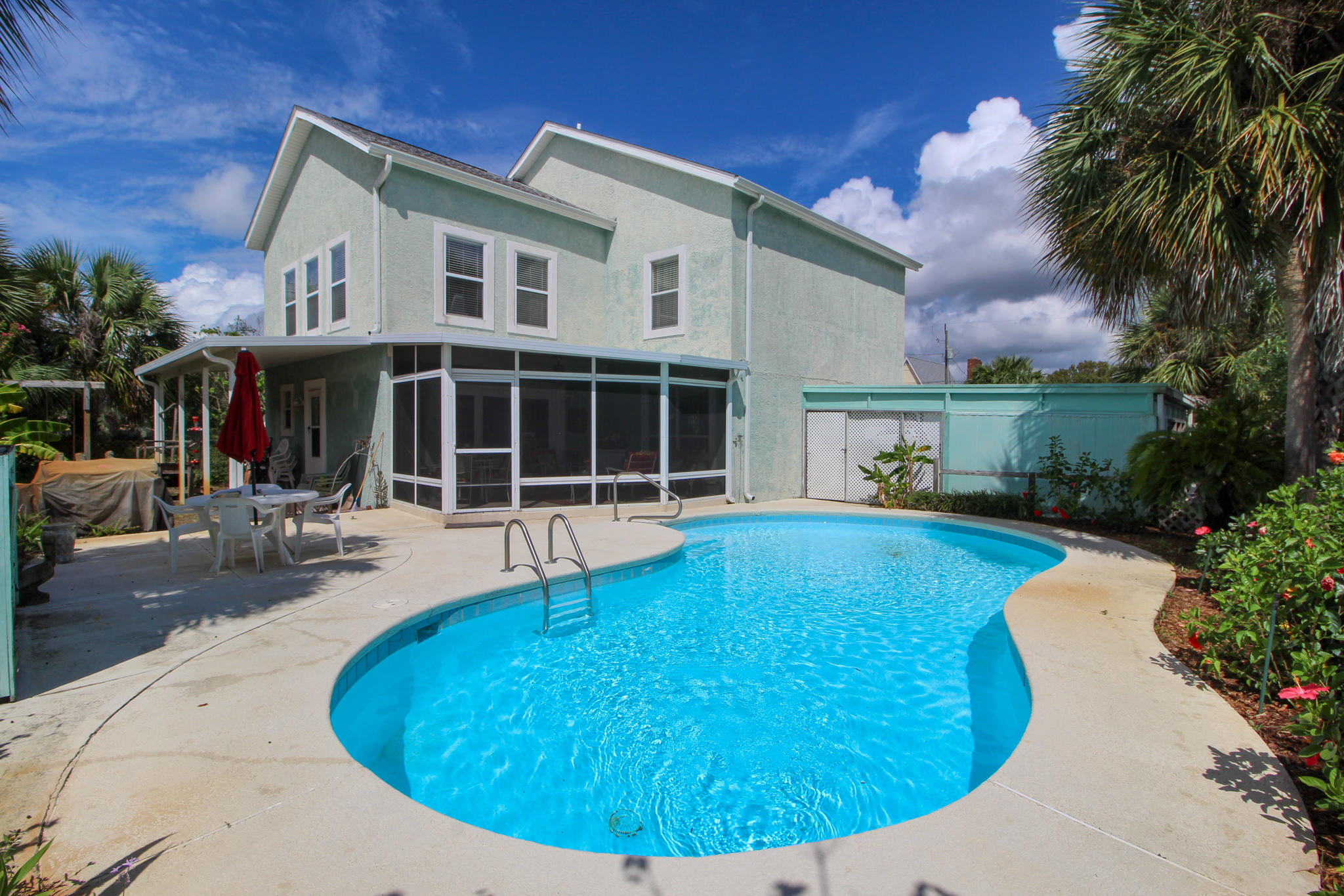 FLORIDA LIVING AT IT'S BEST!   Own a piece of paradise close to the beach with your own in-ground pool! Home is situated on a beautifully landscaped lot with a covered front porch and brick courtyard pavers.  Step inside the foyer to find tiled flooring, glass block window for natural lighting, crown molding, and staircase that leads upstairs.  Spacious  formal living area with built-in surround system.   Gourmet kitchen with lots of quartz counterspace, custom cabinets, upgraded appliances to include double ovens, recessed lighting, crown molding and large center island with built-in breakfast bar.  Dining area is open to the kitchen making entertaining a breeze. Large family room with large windows overlooking the screened-in patio and in-ground pool and two access doors to the backyard. A hidden staircase is found in the laundry room that leads upstairs to the office/game room/den or 4th bedroom. Upstairs master bedroom has a large walk-in closet.  Master bath has double vanities with a make-up station, linen closet, corner whirlpool tub and a large separate shower.  Two additional good-size bedrooms and a full bath with sky light.  Just imagine relaxing in your screened-in patio or entertaining around the pool with extensive cool decking and an open patio area for cookouts.  New roof in 2019 and HVAC system is approximately 2 years old.  Call today for your own private viewing!