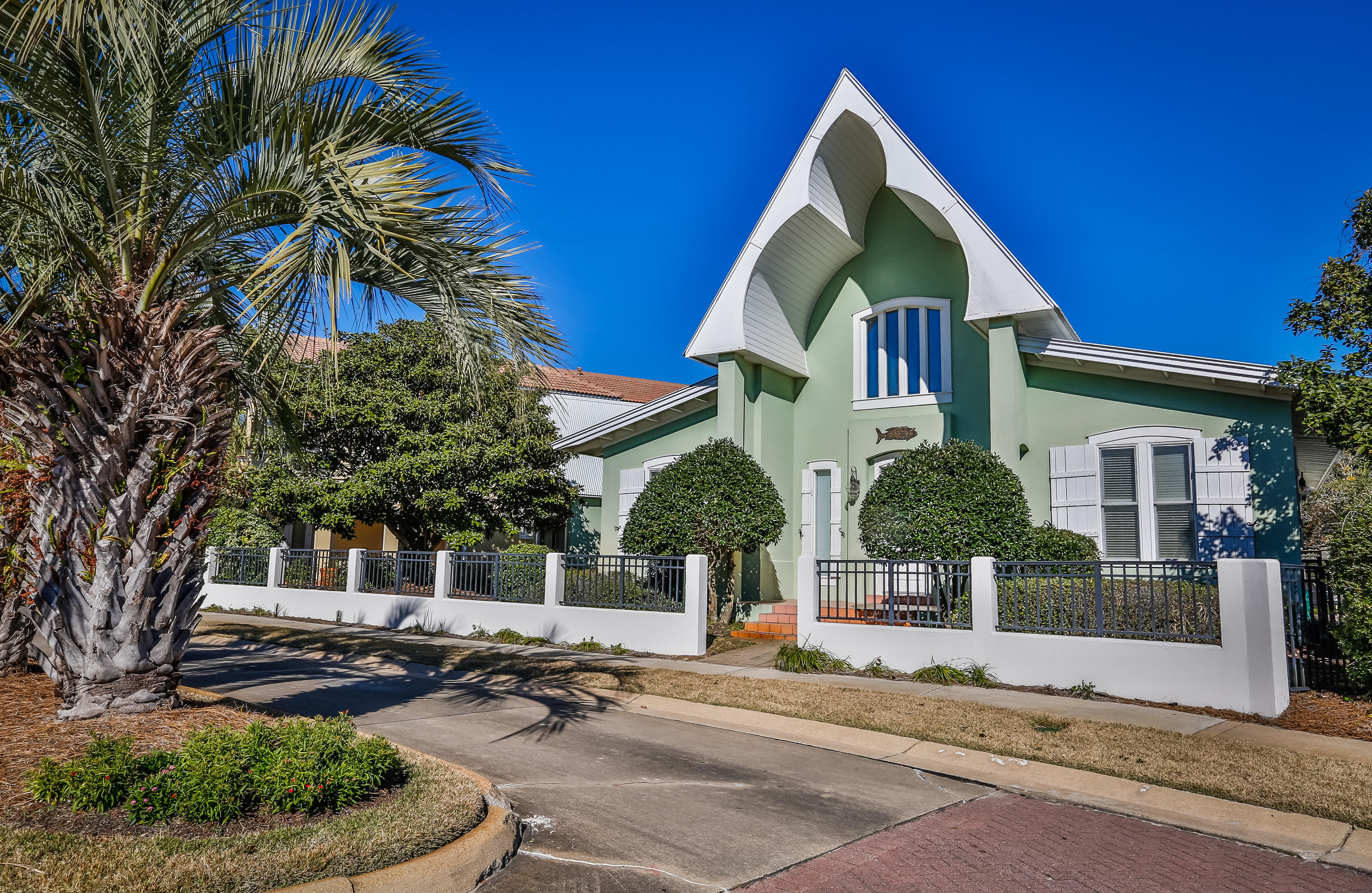 Affordable Caribbean inspired beach cottage with full-sized heated pool. Comfort meets cute in single floor living. This cozy and airy beach house which is less than a 5 minute walk to the Gulf offers the versatility to be either a vacation rental, or your relaxing home to enjoy year-round. Caribe is a guard-gated community in South Walton County with some of the Emerald Coast's deepest private beaches. The community of only 120 homes offers daily beach chair service, two neighborhood pools, and private tennis courts. On this home's very private lot which is adjacent to green space, you will find lush shrubbery encompassing a private pool and deck, coupled with a screened-in porch overlooking the heated pool. The detached garage and extra storage space provide a generous amount of room for pool accessories storage. Once inside the open floor plan, featuring vaulted ceilings with exposed beams, creates an exceptional space perfect for entertaining family and friends. The kitchen's white ceramic tile countertops reflect the whimsical feel of the home. The large, arched pass-through to the dining room fosters the open flow of conversation and memories to be shared from the room where the meals are prepared to the room in which they are enjoyed. The first floor also hosts the expansive living room with 2-story vaulted ceilings, a wet bar area with an under-counter wine rack, and a separate sitting room, all of which are brightened with natural light. The master suite with a spacious walk-in closet is conveniently located on the first floor. The enchanting spiral staircase leads to a second floor loft bedroom with a en suite. This home comes fully furnished with the exception of artwork. This is a home where memories are created. Call for your private showing today!!
