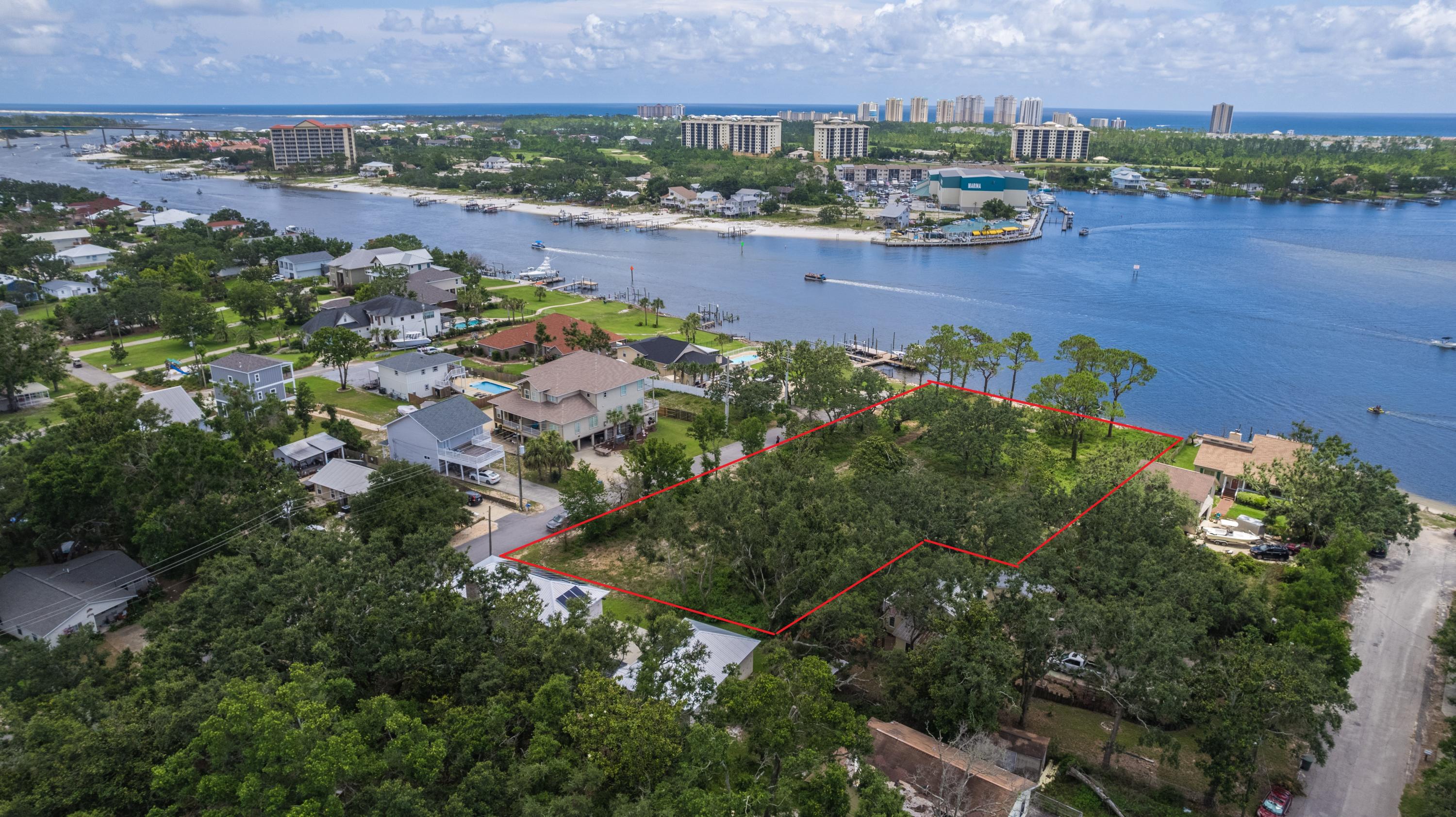 Build your DREAM HOME on this rare magnificent 1.22 acre waterfront lot situated on Innerarity Point with 160 feet of waterfront footage on deep water. This property offers quite a few opportunities that can be explored immediately or planned for regardless of personal use or improving the marketability in resale for all or part of it down the road. The water frontage could comfortably accommodate 2 large single family homes with additional single family lots on Ucita for spec build opportunities or to be sold separately at any point. On the opposite end of allowable density, the Medium Density Residential zoning would also allow for up to 10 units per acre in a Planned Unit Development (PUD), such as building townhomes with a community dock with slips and amenities. This lot has been cle Build your DREAM HOME on this rare magnificent 1.22 acre waterfront lot situated on Innerarity Point with 160 feet of waterfront footage. This property offers quite a few opportunities that can be explored immediately or planned for regardless of personal use or improving the marketability in resale for all or part of it down the road. The water frontage could comfortably accommodate 2 large single family homes with additional single family lots on Ucita for spec build opportunities or to be sold separately at any point. On the opposite end of allowable density, the Medium Density Residential zoning would also allow for up to 10 units per acre in a Planned Unit Development (PUD), such as building town homes with a community dock with slips and amenities. This lot has been cleared with only Live Oaks remaining on the property and rip rap in place. Enjoy endless sunsets overlooking Ole' River. Minutes to the beach on Perdido Key and enjoy the new public waterfront park on Innerarity point and walk to Hub Stacy's just one street over. Enjoy Florida's living at it's finest. No tap fees have been paid. Zoned MDR (Medium Density Residential). See our video tour on the MLS and YouTube.