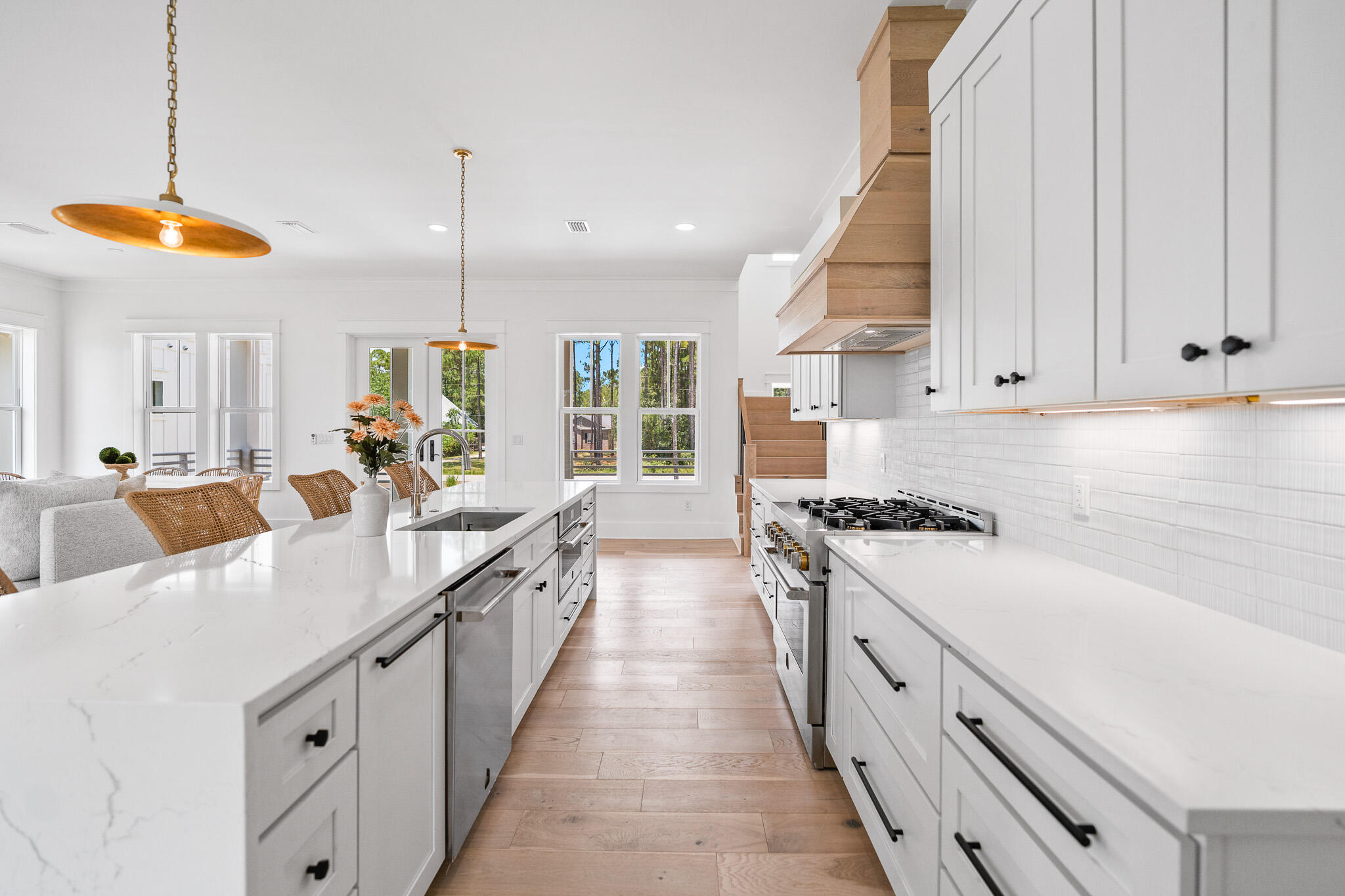 This is an exceptional new construction residence offering direct access to Choctawhatchee Bay, thoughtfully designed with upscale finishes, flexible living spaces, and no HOA-bring your boat, RV, or water toys and enjoy true coastal freedom.

Spanning three levels, this home opens to an expansive open-concept layout flooded with natural light and anchored by neutral hardwood floors throughout. A custom iron staircase adds a striking architectural detail as you move through the space. The chef's kitchen impresses with quartz countertops, a waterfall-edge island with bar seating, stainless steel appliances, a six-burner gas stove, and a custom wood range hood. A large walk-in pantry is tucked behind showcasing custom cabinetry and provides exceptional storage. A stylish powder room just off the kitchen features designer touches to wow your guests along side a spacious bonus room, ideal for a media or game room!

The primary suite, privately situated on the main level, offers breathtaking water views and a luxurious en-suite bathroom with dual vanities, a large walk-in shower with glass enclosure and floor-to-ceiling tile, white gold hardware, and a soaking garden tub-a perfect retreat after a day on the bay.

Upstairs, you'll find 3 guest bedrooms, each with their own en-suite bathroom, along with a loft area great for a study space. 

Outdoor living is elevated with spacious, covered balconies featuring wood-detailed ceilings, creating a cozy and inviting space year-round. The covered two-car carport below doubles as an entertaining space that is perfect for gatherings in any season as an extension to the interior space.

And the best part? Your private dock with boat lift means you're just steps away from open water adventures in the bay and bayou for sunset cruises. The water depth ranges from 3-4 feet throughout the year, making it suitable for pontoons, center console boats with a shallow draft, jet skis, kayaking and paddle boarding!

This home is a rare blend of luxury, functionality, and waterfront living- positioned just 20 minutes to the coveted 30A and 10 minutes into SanDestin for shopping, dining, and beautiful white beaches. Furnishings are negotiable and the back yard possibilities are endless with space for a pool, putting green, and more as shown in the renderings.