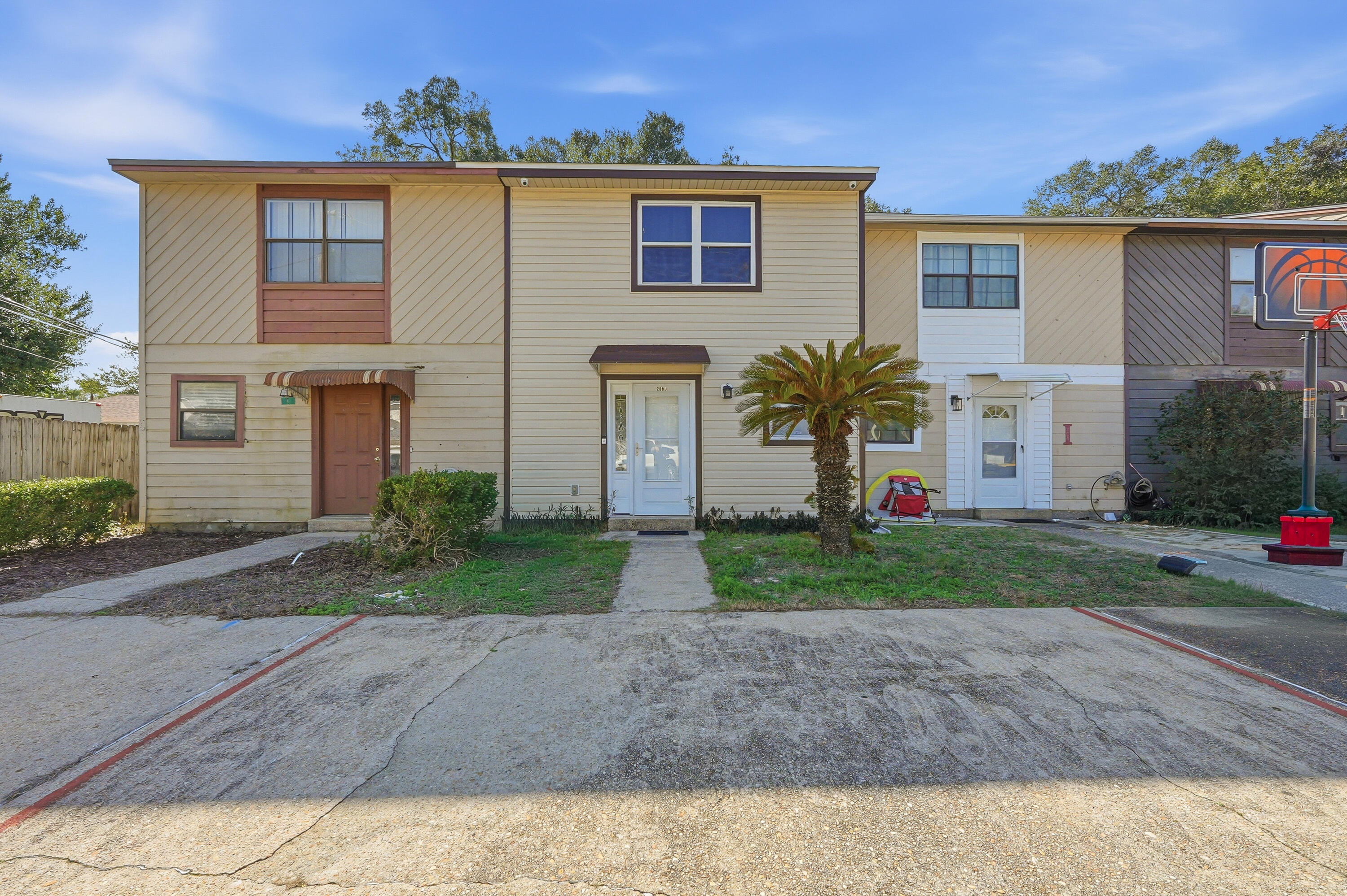 Welcome home to this charming, move-in-ready townhome in the heart of Fort Walton Beach. Freshly painted and well maintained, the interior features tile flooring throughout the first floor and wood laminate upstairs. Step outside to a private patio with a large storage closet and a fully fenced backyard—perfect for pets, morning coffee, or relaxing evenings. Upstairs, the spacious primary suite offers a walk-in closet, vanity and dressing area, and private access to the bathroom. A generously sized second bedroom is ideal for guests or a home office. Downstairs includes a convenient laundry room and half bath. New roof in 2021. No HOA. Enjoy an easy 1.5-mile drive through downtown shopping and dining on your way to the beautiful sugar white sandy beaches of the Emerald Coast!
