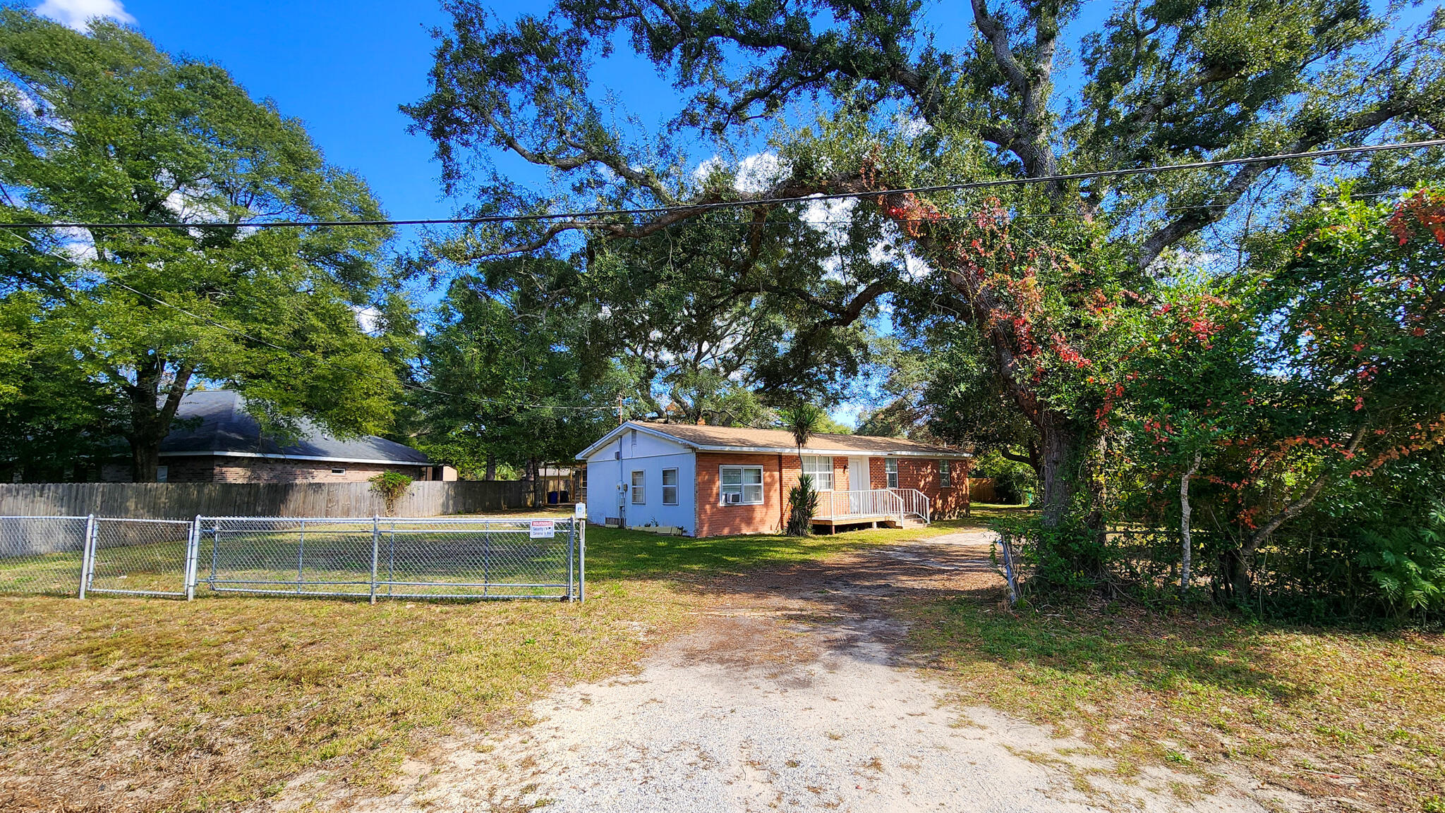 Welcome to 1200 Forest Heights Road in Fort Walton Beach, Florida 32547! This charming three-bedroom, two-bathroom home sits on a spacious 0.34-acre corner lot that not only offers privacy, functionality, and room to grow, but also provides the opportunity to be split into two separate lots.

The property is fully fenced and features two backyard sheds perfect for storage, hobbies, or a workshop. A large deck offers the ideal space for relaxing or entertaining, while the inviting walk-up front porch creates a warm and welcoming entryway.

Inside, you'll find open living and dining areas that create a comfortable, flowing layout. Large windows fill each room with abundant natural light, enhancing the bright and airy feel throughout the home. A new roof installed in 2024 adds peace of mind and long-term value.
Conveniently located in the heart of Fort Walton Beach, this home offers quick access to local schools, shopping, and military bases while still giving you the space and privacy you want. This is a wonderful opportunity you won't want to miss!