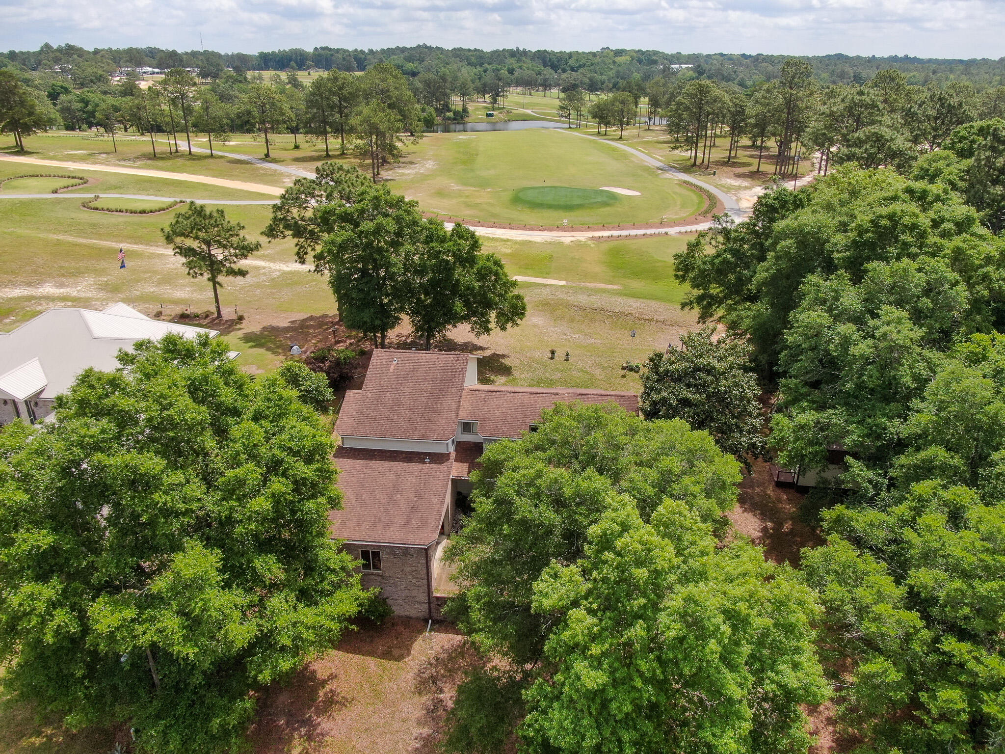 Welcome to this stunning golf course home, a true gem located on the 5th hole of Eagle Springs Golf Course. This beautiful two-story home offers 3 bedrooms/2.5 baths, with a downstairs master suite. You're greeted by a soaring cathedral ceiling in the living room and beautiful hardwood floors, with fantastic views of the golf course. The floor plan is ideal for entertaining family and friends, complete with a wet bar, which doubles as a butler's pantry. Continue through to the formal dining area and the spacious kitchen, an ideal natural gathering place. Step out back to a gorgeous golf course view and a wrap-around screened porch with newer Trex decking, which is outfitted perfectly with overhead fans and cable for game day fun. The master bedroom is quite generous in size, with an equally impressive master bath; featuring his and hers vanities, a new separate shower, and a large soaking tub, which all comes together to create a true spa-like feel. The separate private porch off the master bedroom provides a cozy spot for enjoying morning coffee or evening drinks.
Upstairs, you'll find 2 bedrooms, full bath, den/flex space (future 4th bedroom perhaps?) plus a loft overlooking the living room, which could make a great office or homework/play area. The den/flex space connects to the newly created sunroom, which has a convenient outside entrance and provides additional versatile space. The entire home has been exceptionally maintained and tastefully appointed, making it move-in ready for its new owners. Updates are plentiful and include striking new front door, new plantation shutters, and updated paint inside and out, just to name a few. Additionally, there is even an unfinished, below grade space for extra storage. This is truly a rare opportunity in DeFuniak Springs to live adjacent to the city's municipal airport, directly on the golf course, and at the end of the dead-end street for added privacy. It is sure to impress even the most discriminating buyer.