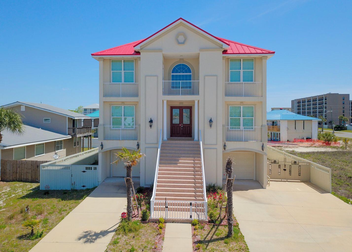 This large home with its gulf views and location across the street from a beach access is perfect for family getaways or company retreats.  As you walk into the house you are instantly hit with an elegant 20' foyer that is highlighted by a ceiling decorated as if you were looking at the sky and sets your mood perfectly for your stay at the beach.  There is an elaborate hardwood staircase, beautiful chandeliers, and comfortable furniture place throughout the house. The enormous kitchen is a gourmet's dream, with a large island/breakfast bar, with granite counter tops, white cabinets, and stainless-steel appliances.  As you explore the first floor you will find another family room, full kitchen with gas stove, dining room and two more bedrooms for your guests and entertaining. The first floor has another family room, full kitchen with gas stove, dining room and two more bedrooms for your guests and entertaining. Easily adaptable for both home theater and gaming space.

These rooms are easily adaptable for both home theater and gaming space.  Jump to the third floor and you will find another open family room and 4 bedrooms. The covered decks are perfect for enjoying beautiful sunsets with views of the Gulf and Santa Rosa Sound. Again, this house is ideal for family getaways or corporate retreats.