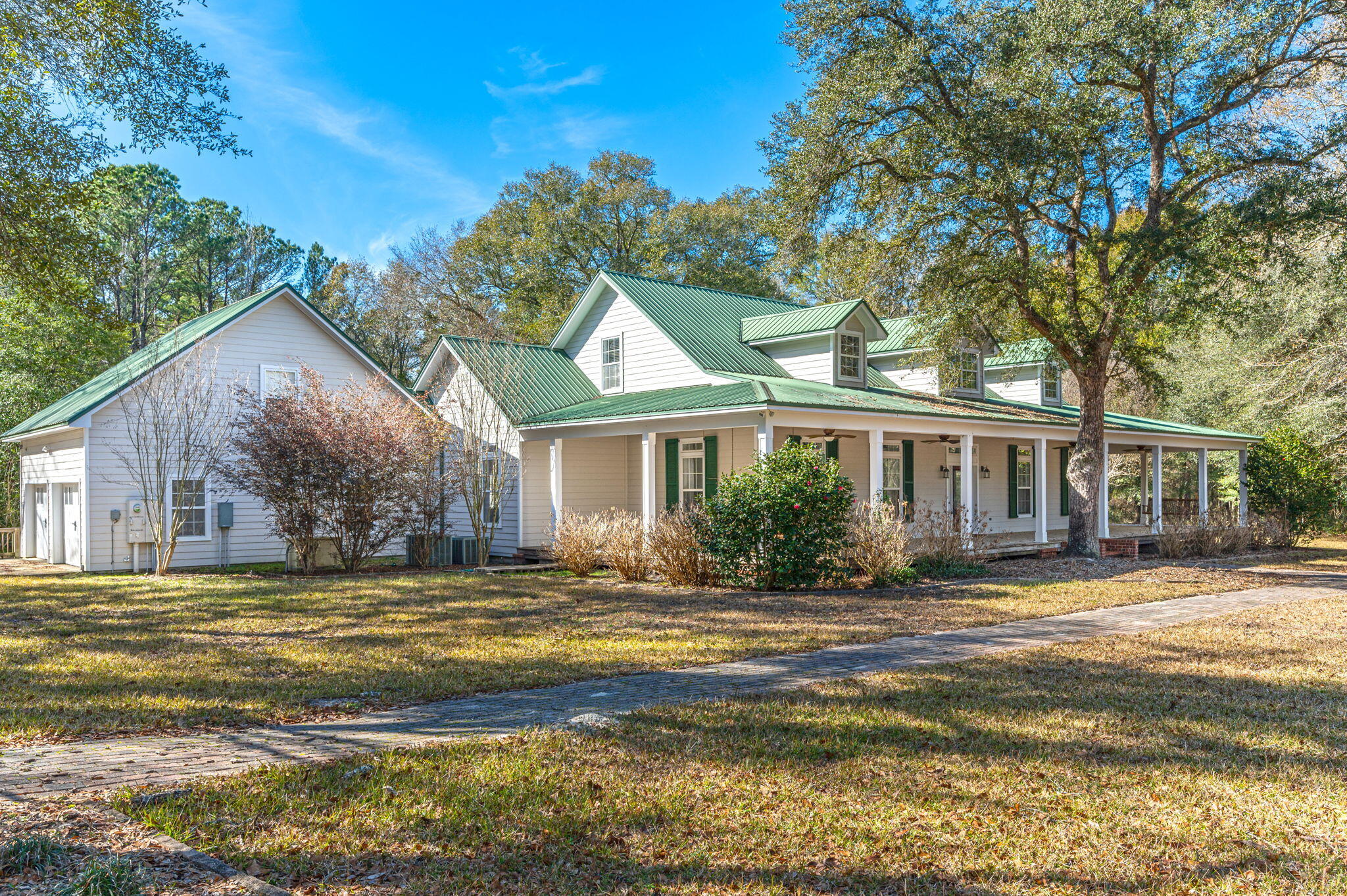 This Southern Charmer 130 acres and a custom-built farmhouse-style estate is a real hidden gem here in North Walton County. 130 acres surrounded by pastures, multiple barns, and massive oak trees Workshop, 4 wells, and 3 septic tanks. Notice the 12 ft wrap-around porch with multiple porch swings! Step into this breathtaking home where the flooring was hand-cut from the trees on this very property! Built-in bookshelves on the staircase lead you upstairs to an office nook, full bathroom, game room, and two bedrooms. The Luxurious Kitchen features Double kitchen islands both with sinks, a subzero refrigerator, a Thermador gas stove, a pot filler, a double oven, a microwave, and an icemaker... The huge walk-in pantry is a canning room delight all to itself!
Double Brick-styled fireplace in the living room and master bedroom. The master bathroom
features a jacuzzi-styled garden tub, a double vanity sink, and a separate shower. Continue your
journey into the Florida room which will lead you to decks galore, a large screened-in sitting
room with a wood-burning stove, a grilling area, and an outdoor shower! The property has a
secluded winding driveway through the pastures, and pecan orchards past the pond, and over the
(mock) bridge for a grand entry. The two huge barns have power and water, one has a custom
woodworking shop with all the equipment! Bring the fishing poles for bream and catfish or the
horses, four-wheelers, or dirt bikes to explore miles of trails. There are deer and turkey galore.
Horse paddocks, fenced and cross-fenced pastures lots of beautiful pecan trees in the orchard.
Multiple home sites with wells and septics. There is so much to say about this one-of-a-
kind property, so come see for yourself. Too many hours of custom touches to list! Ooh-Ahh and
Wow!