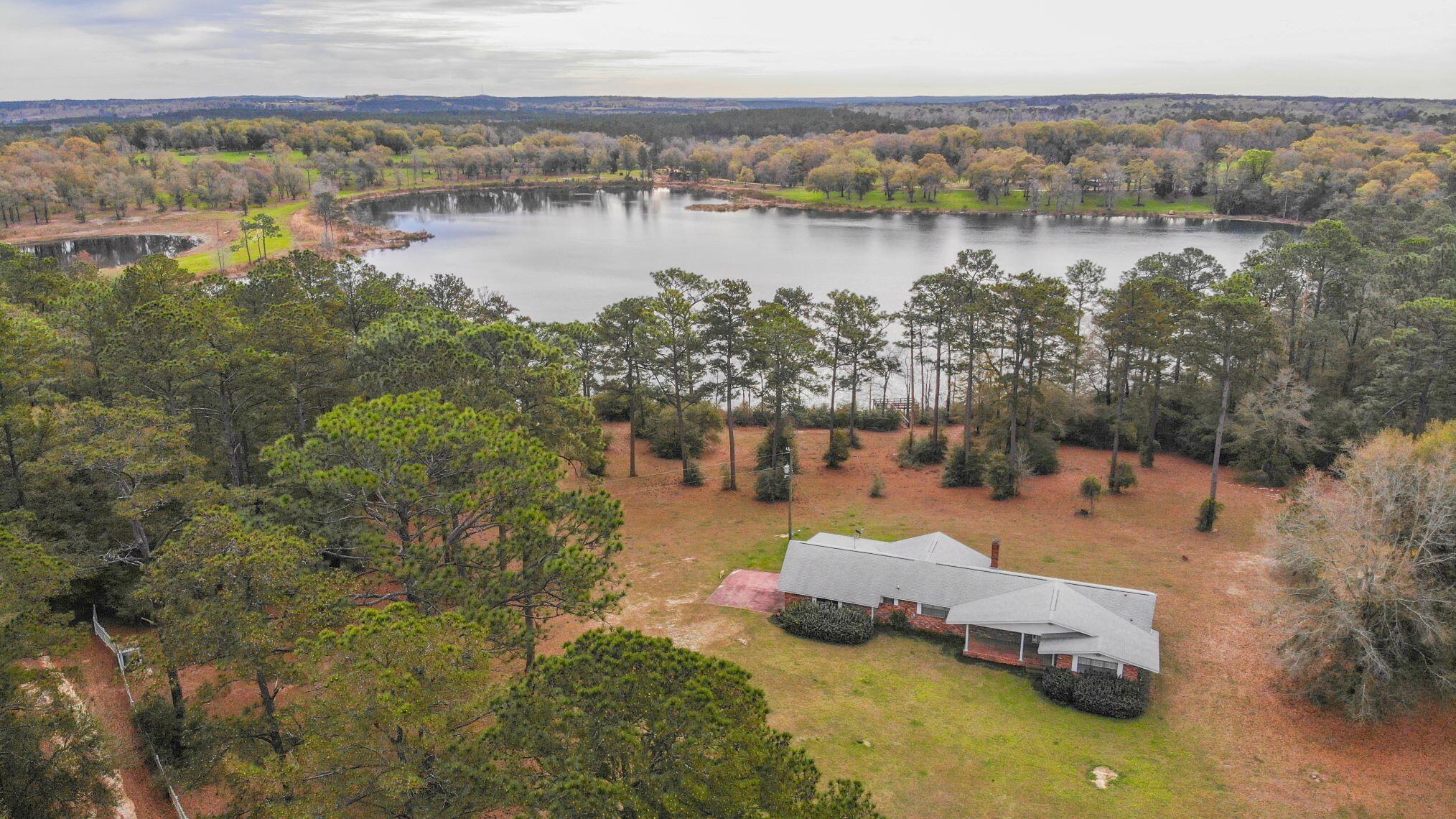 55 ACRE FARM.   30 acres more or less in pasture.  Perfect for horses or cattle.  Subject property has almost  500 feet of waterfront , a private boat ramp and a  private dock on Double Pond a 40 acre natural spring fed lake perfect for swimming, scuba diving and fishing.  Double Pond is  known for its big bass and  bream. The 3 bedroom, 2 bath brick farm house includes an attached garage.   The farm includes a metal 1350 sq. ft.   metal barn with an attached 650 sq. ft. carport and  double drive through garage doors, making access easy in and out  for farm equipment. shown by appointment