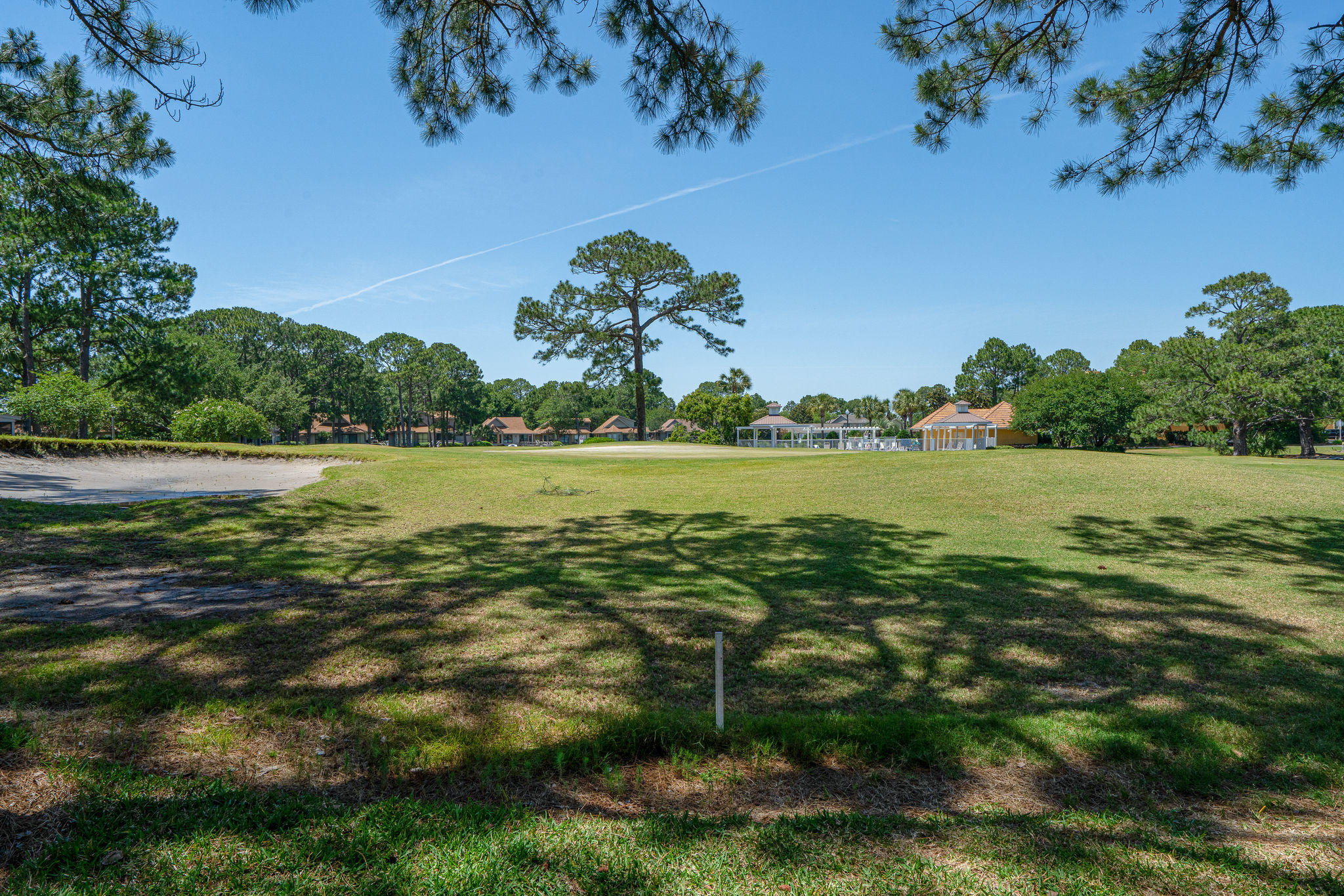 Neatly located within Sandestin Golf and Beach Resort. This spacious, coastal inspired property is perfectly perched along the Links 7th hole with bay and pond views ! Resort living at its finest with an enviable Florida lifestyle. Step inside the light two story foyer and admire the views of the golf course that are evident from almost every room in the house. Plantation shutters, corner windows, tile floors and granite counter tops are just some of the noteworthy features. The family-sized kitchen has clean white cabinets and a full range of stainless appliances. There's everything you need, whether this is a vacation home or full time residence. Offered fully furnished and ready for you A half-height wall creates a handy breakfast bar for three or more and defines the formal dining area. A strategically placed mirror wall reflects the natural daylight and creates the illusion of endless space. Stairs lead up to two bedrooms, both with picture windows framing more tree-lined vistas. From the living room, fling open the French doors and step outside onto the private deck. Imagine enjoying breakfast with just the twitter of morning birdsong, or barbecues with friends beneath the shady scented pines. The green fairway provides expansive views from this maintenance-free yard along with partial views of the shimmering bay beyond. Beyond the resort, Sandestin amenities beckon with Silver Sands Outlet Mall just minutes away and a plethora of restaurants, supermarkets and attractions nearby. The Village of Baytowne Wharf offers boutique shopping and the opportunity for fishing charters and water-sports including kayaking and stand-up paddle boarding. When you live here, every day will feel like a vacation.